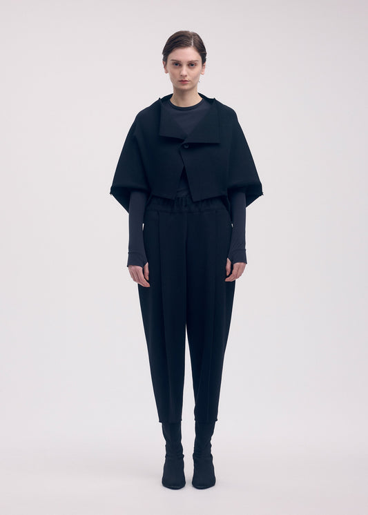 A model wears the ISSEY MIYAKE CAMPAGNE cardigan.