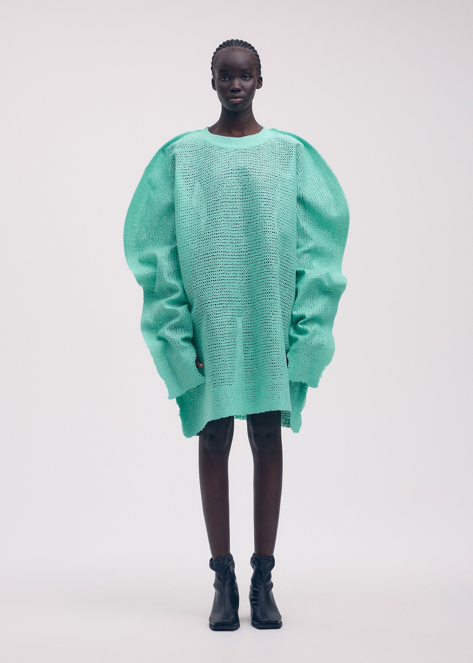 A model wears the ISSEY MIYAKE PANINI tunic.