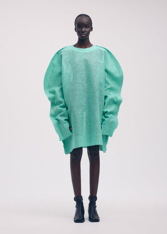 A model wears the ISSEY MIYAKE PANINI tunic.