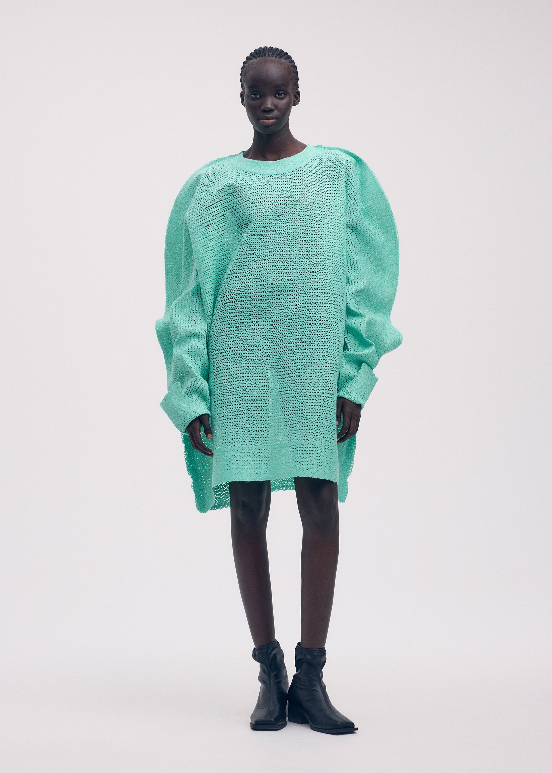 A model wears the ISSEY MIYAKE PANINI tunic.