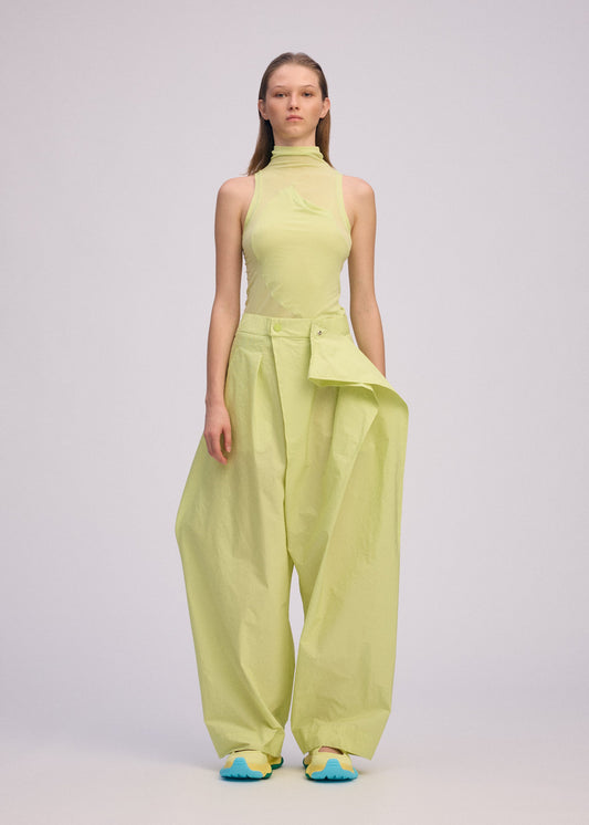 A model wears the ISSEY MIYAKE AKIMBO clothing.