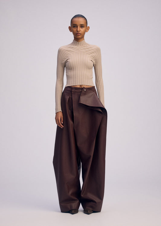 A model wears the ISSEY MIYAKE PRONOUNCED BODY clothing.