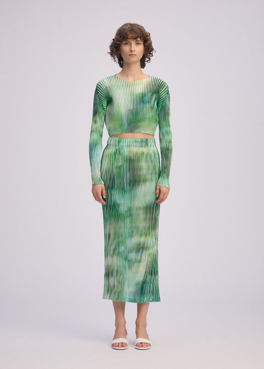 A model wears the ISSEY MIYAKE OBSCURE PLEATS clothing.