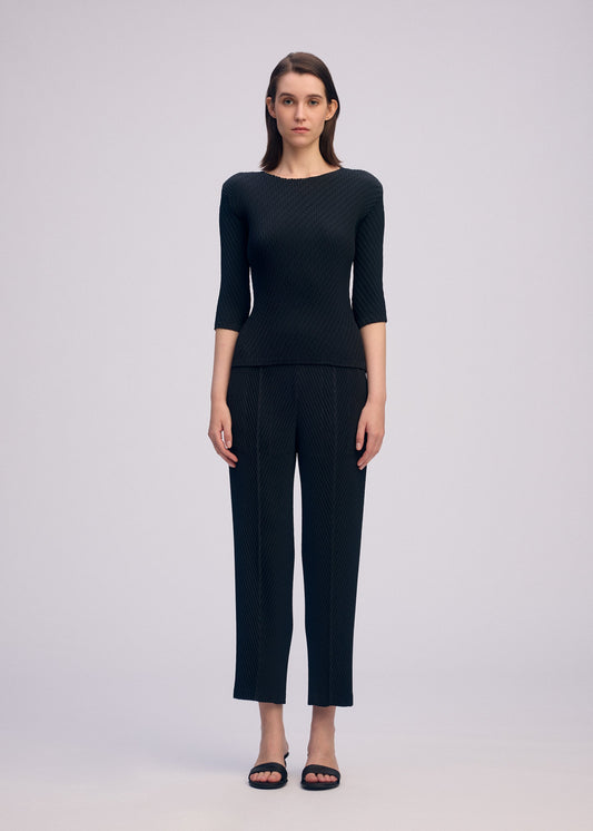 A model wears the ISSEY MIYAKE RHOMBUS PLEATS shirt.