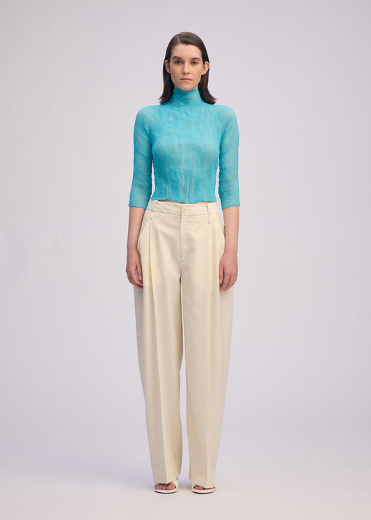 A model wears the ISSEY MIYAKE CHIFFON TWIST 2 shirt.