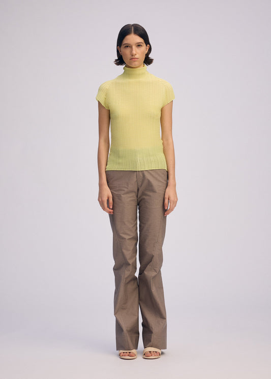 A model wears the ISSEY MIYAKE WOOLY PLEATS 66 clothing.