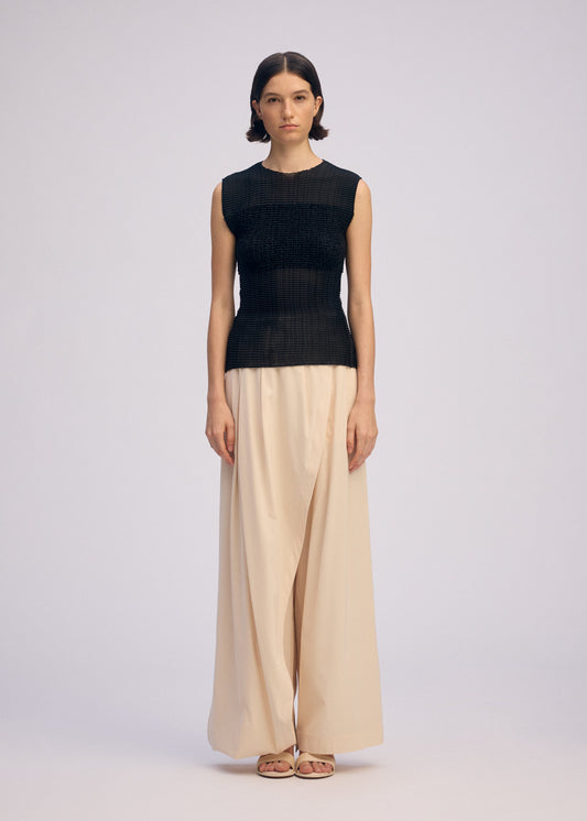 A model wears the ISSEY MIYAKE SHEER FUZZY PLEATS shirt.