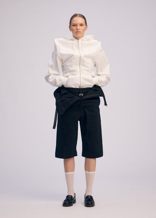 A model wears the ISSEY MIYAKE GENERIC WEAR cardigan.