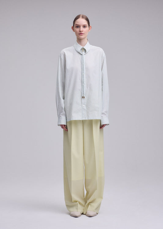 A model wears the ISSEY MIYAKE MONSIEUR SHIRT(DOBBY STRIPE) monsieur-shirt-dobby-stripe-shirt-white-hued.