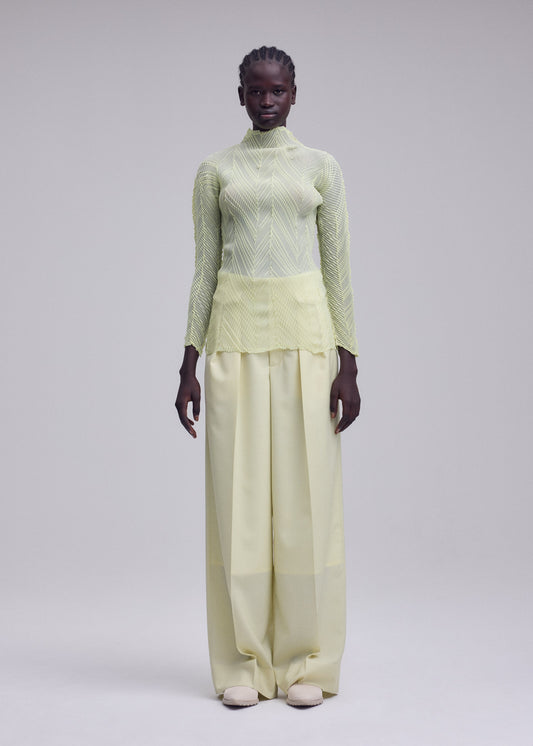 A model wears the ISSEY MIYAKE ZIGZAG PLEATS zigzag-pleats-long-sleeved-top-black.