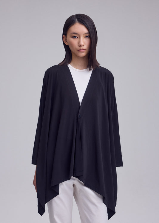 A model wears the ISSEY MIYAKE DRAPE JERSEY-68 drape-jersey-68-cardigan-off-white.