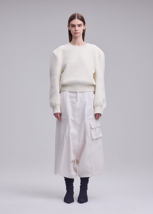 A model wears the ISSEY MIYAKE HANDSOME KNIT handsome-knit-top-off-white.