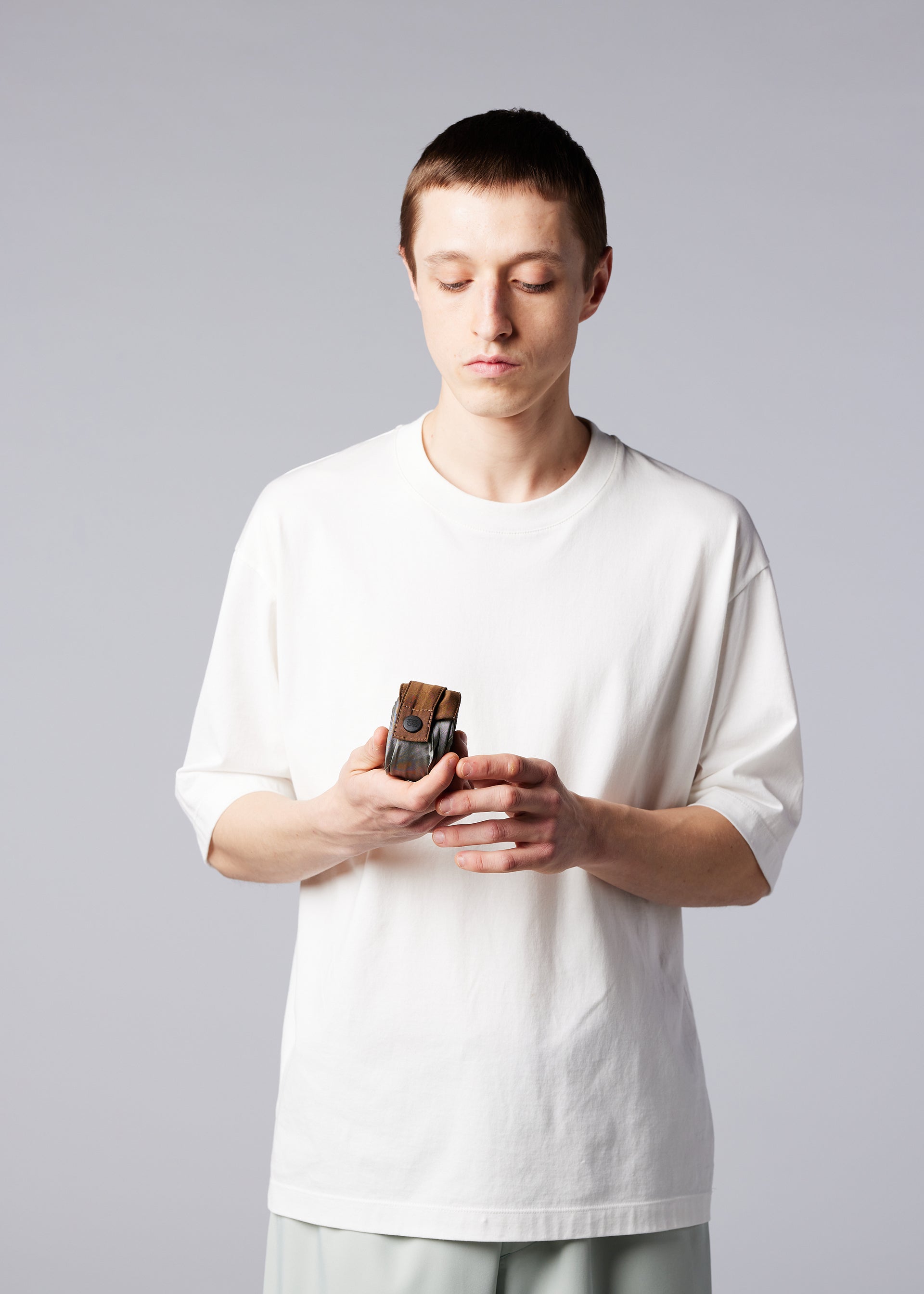 A model wears the IM MEN GURU GURU bag