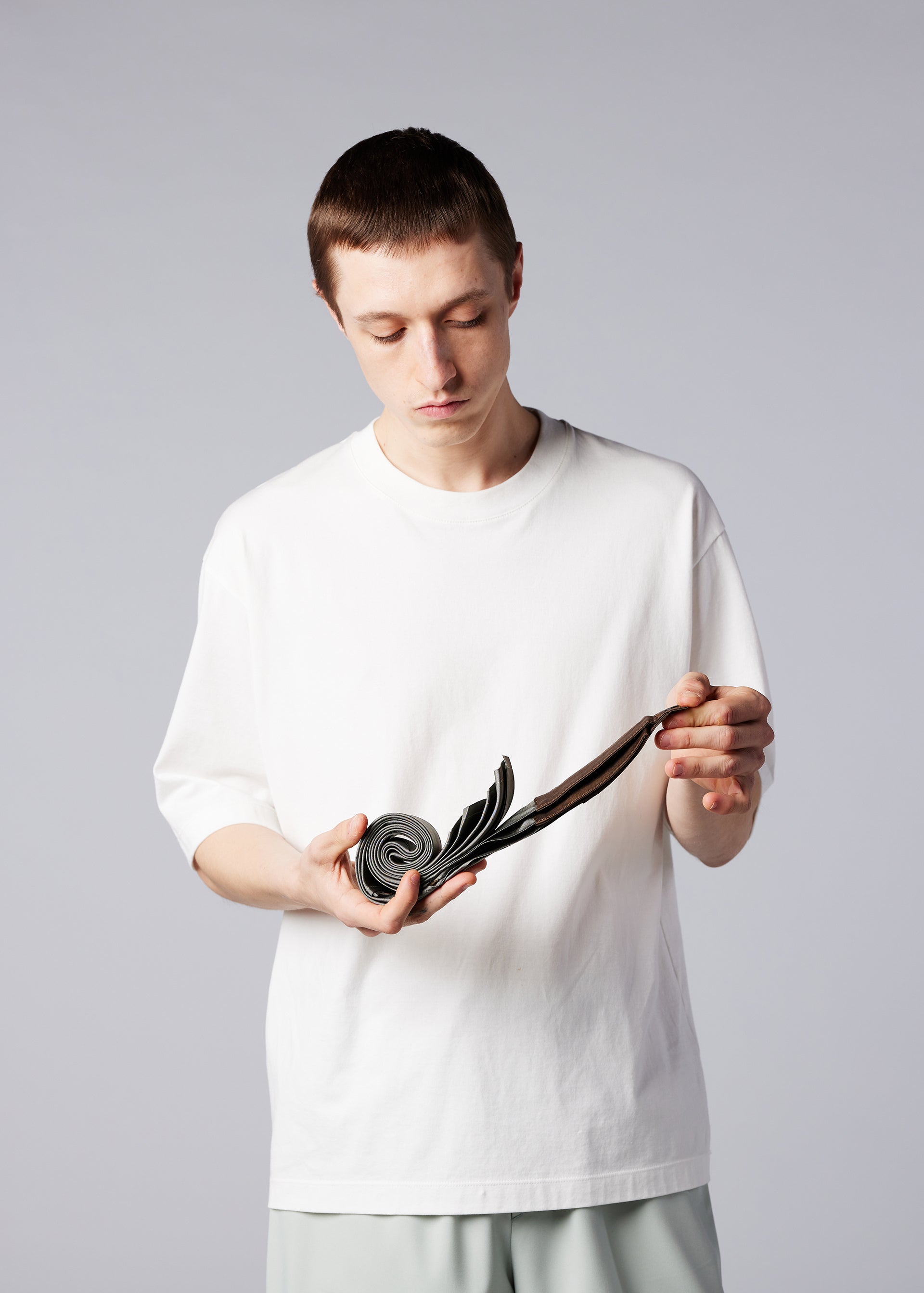 A model wears the IM MEN GURU GURU bag