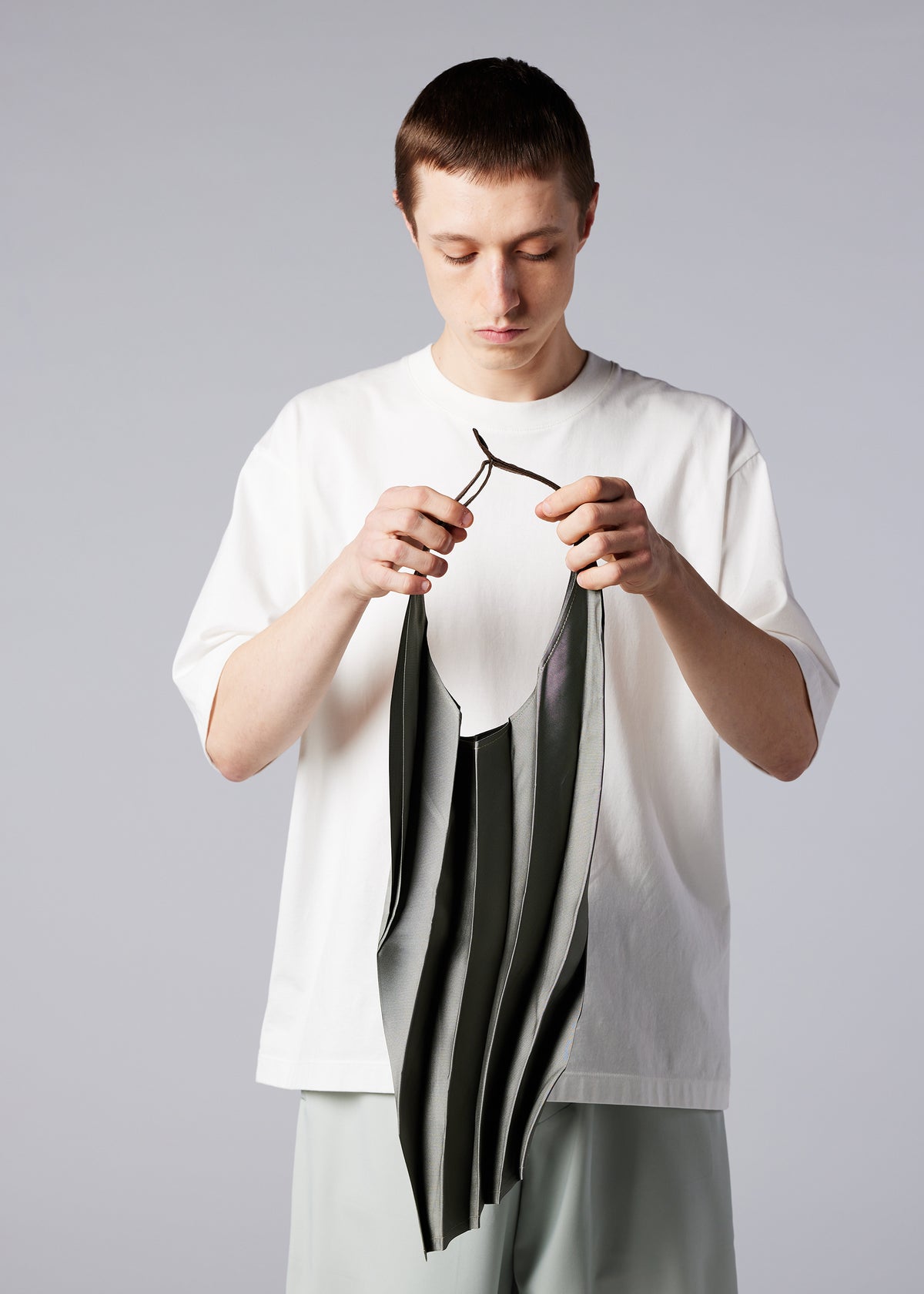 A model wears the IM MEN GURU GURU bag