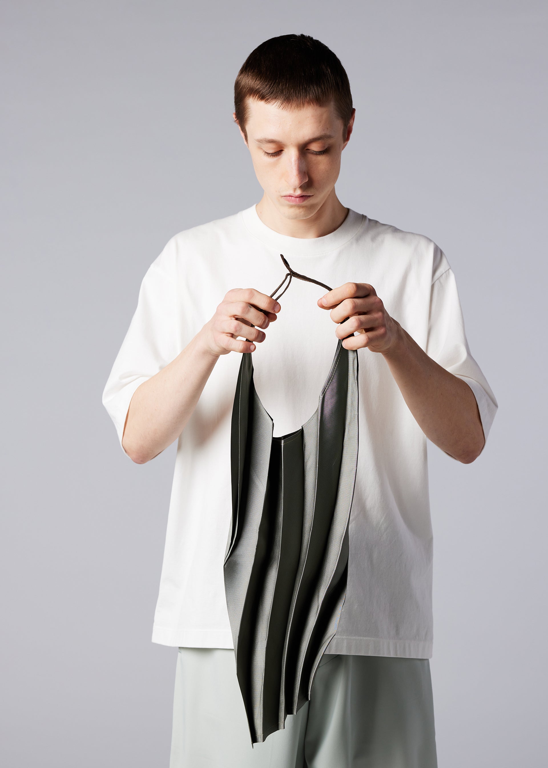 A model wears the IM MEN GURU GURU bag