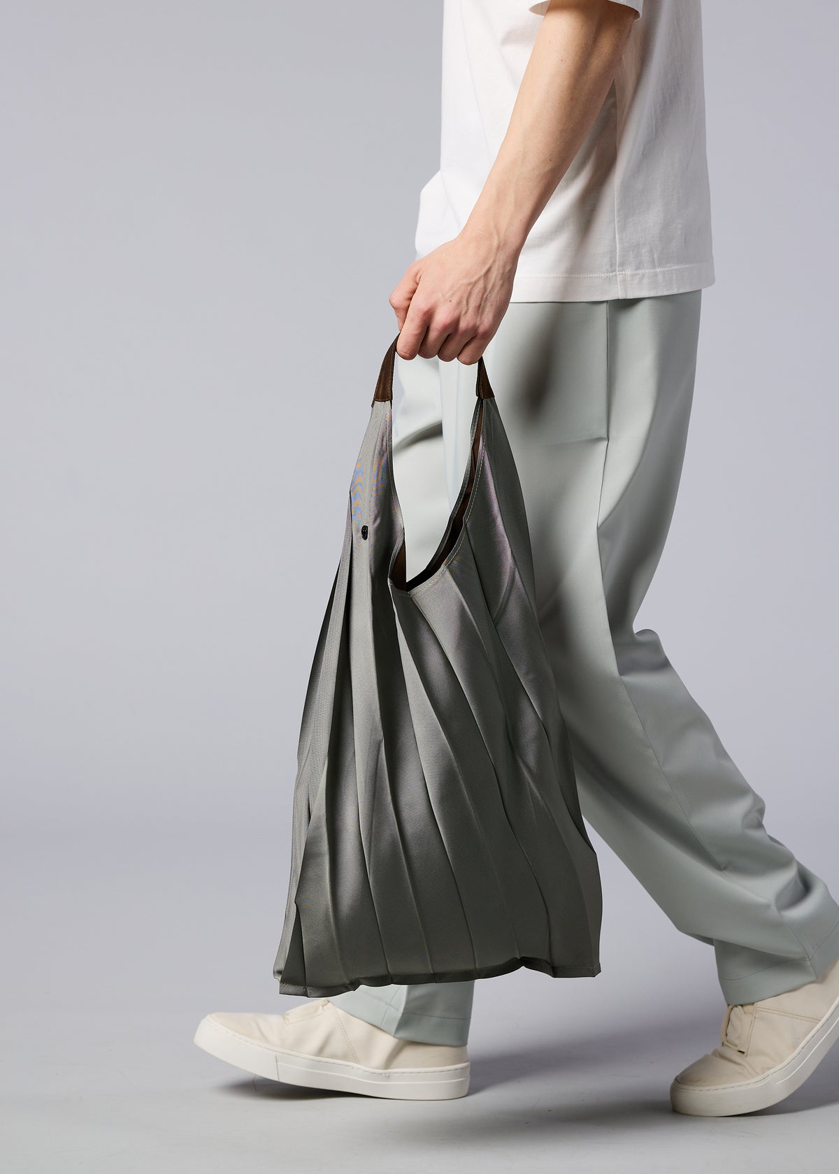 A model wears the IM MEN GURU GURU bag