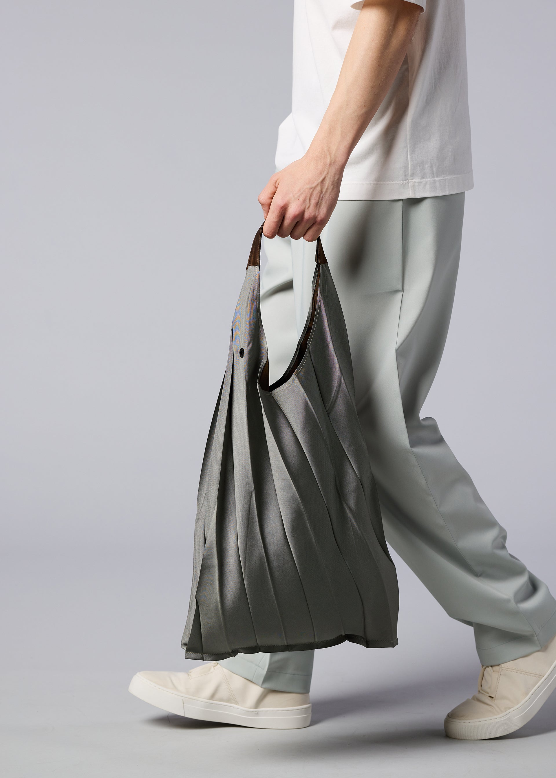 A model wears the IM MEN GURU GURU bag