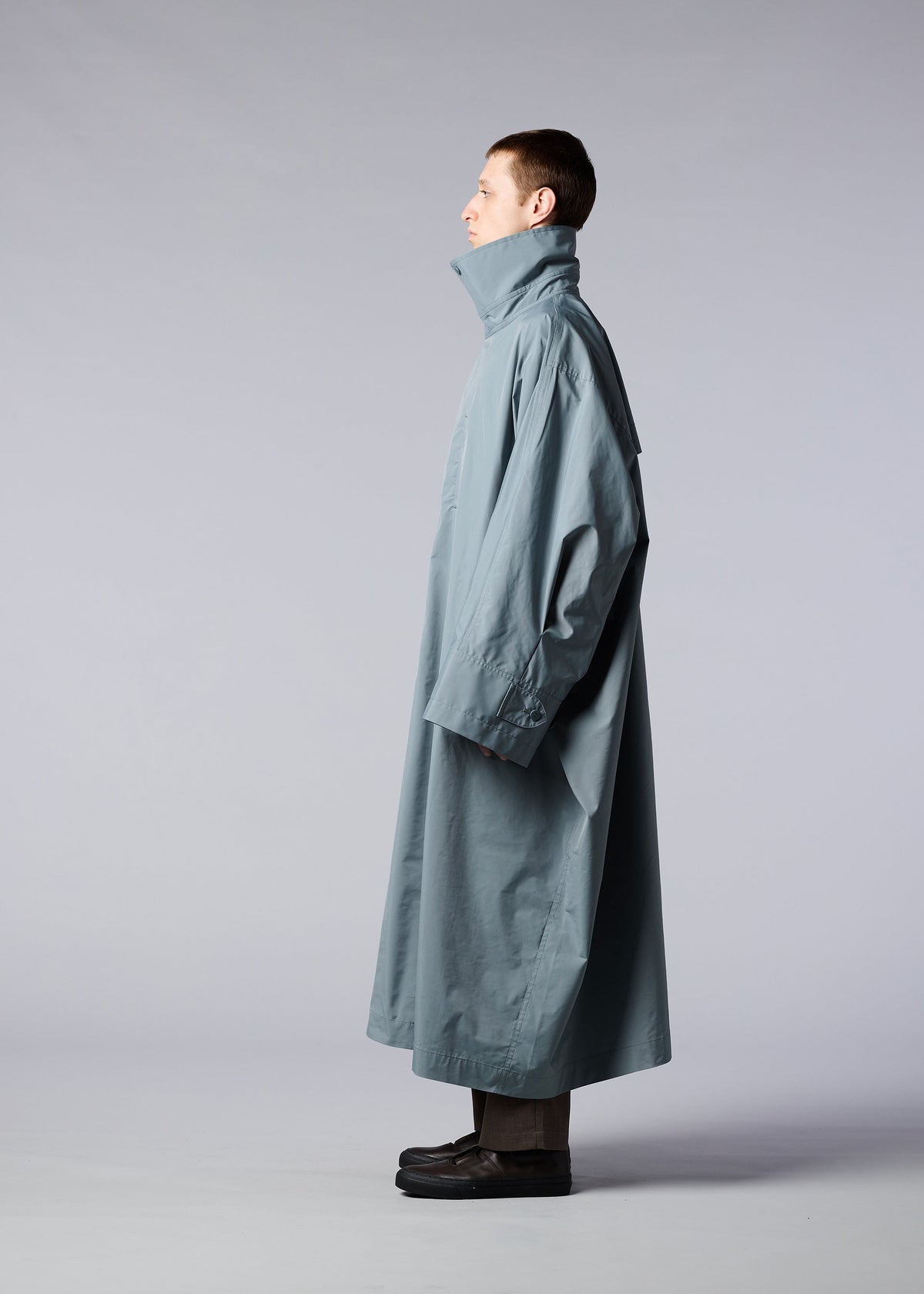 A model wears the IM MEN WIND COAT coat.
