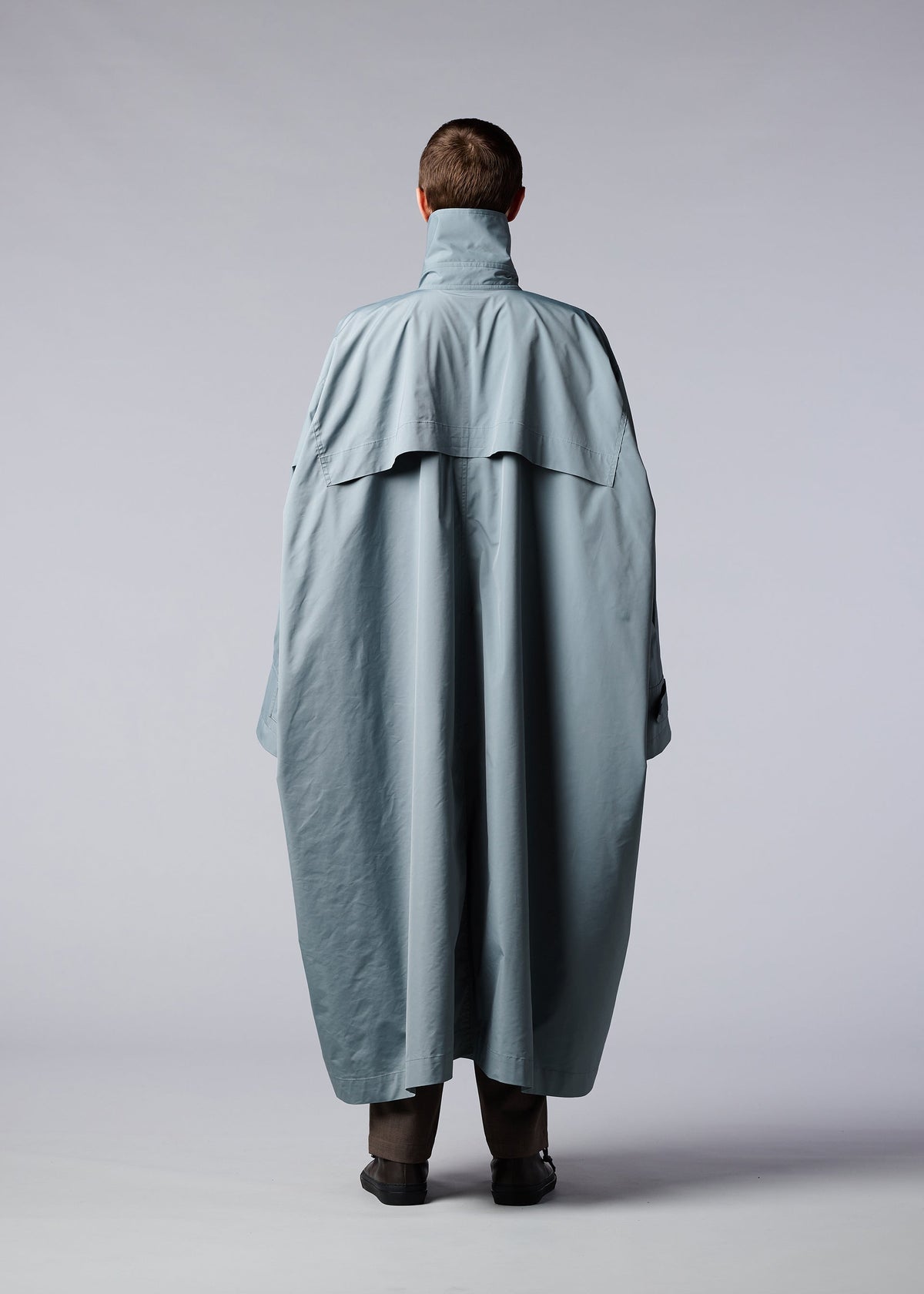 A model wears the IM MEN WIND COAT coat.
