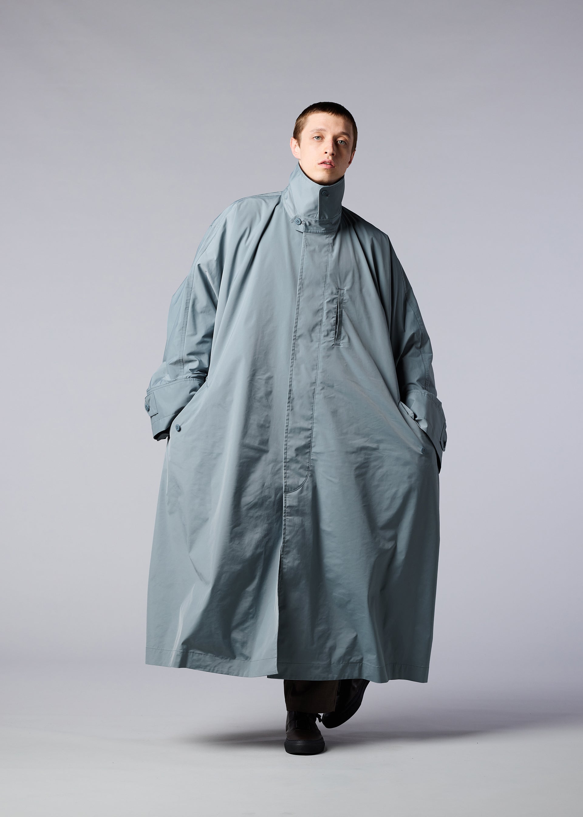 A model wears the IM MEN WIND COAT coat.