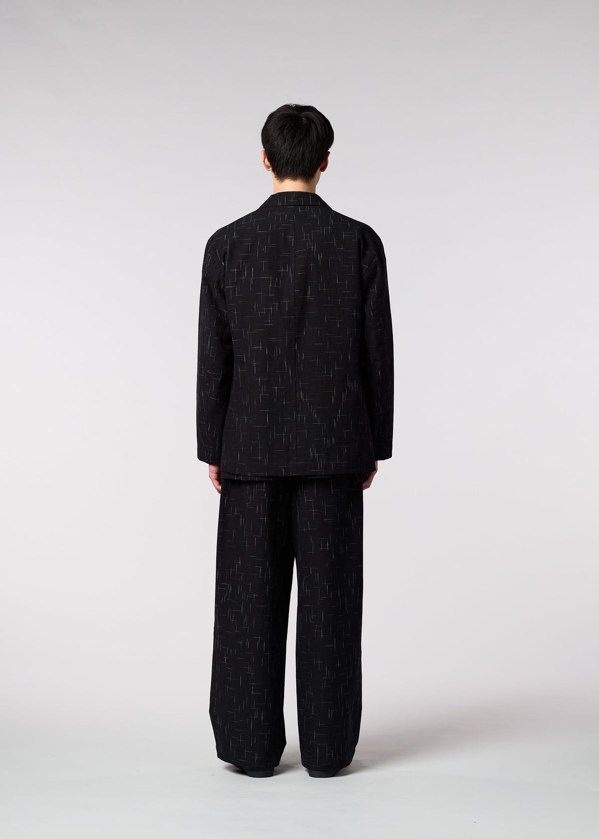 A model wears the IM MEN KASURI jacket.