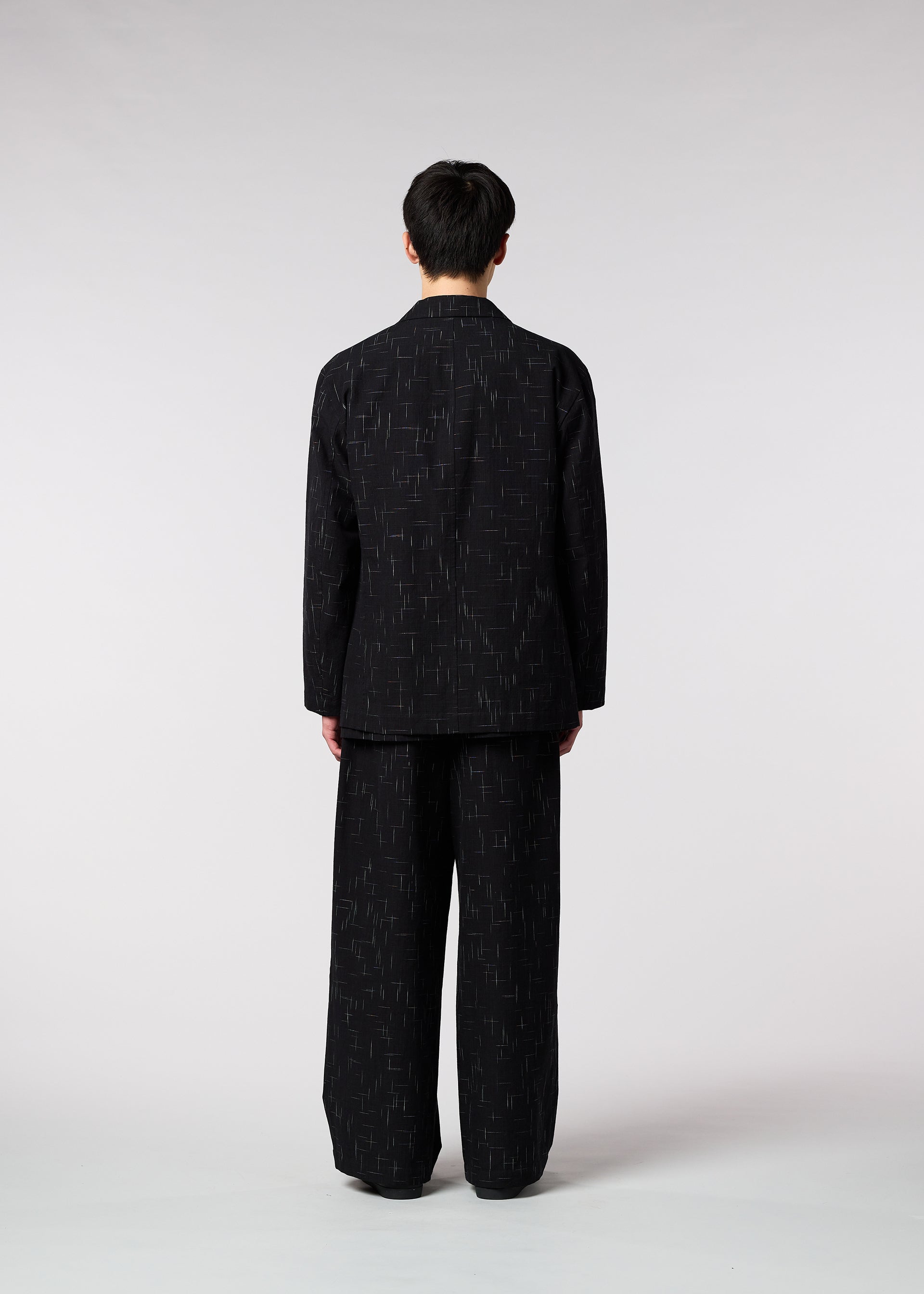 A model wears the IM MEN KASURI jacket.