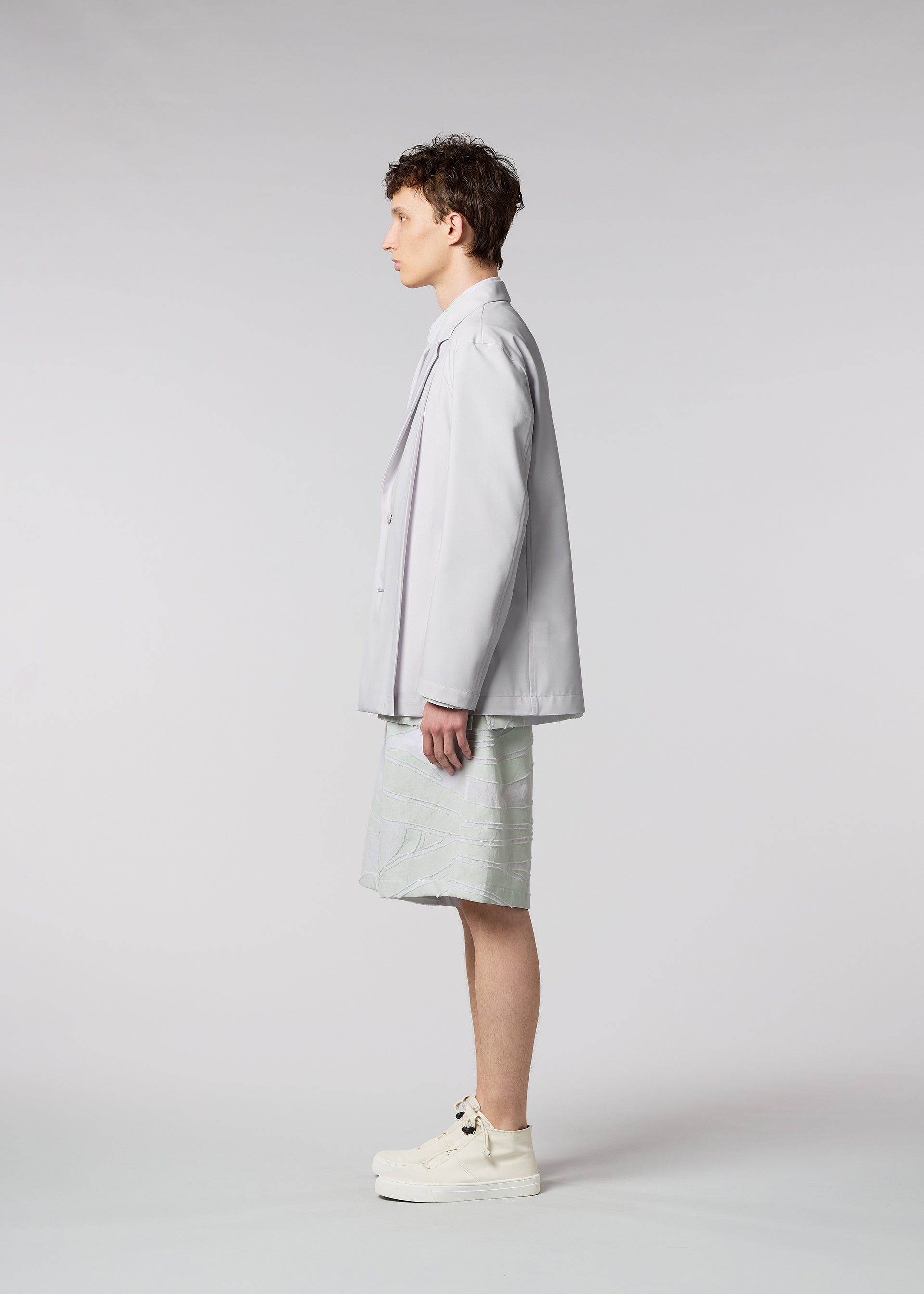 A model wears the ISSEY MIYAKE MEN WINGS jacket.
