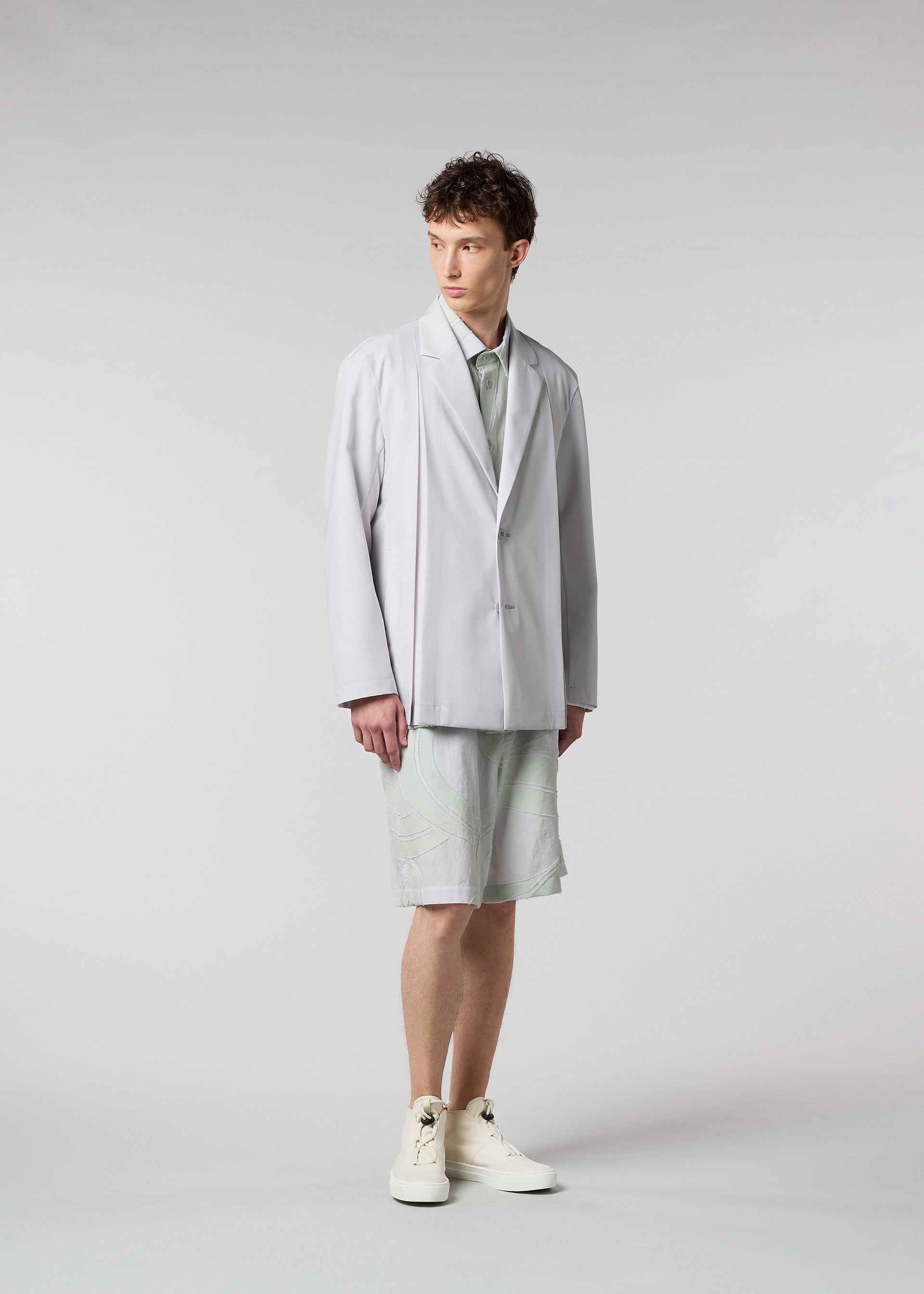 A model wears the ISSEY MIYAKE MEN WINGS jacket.