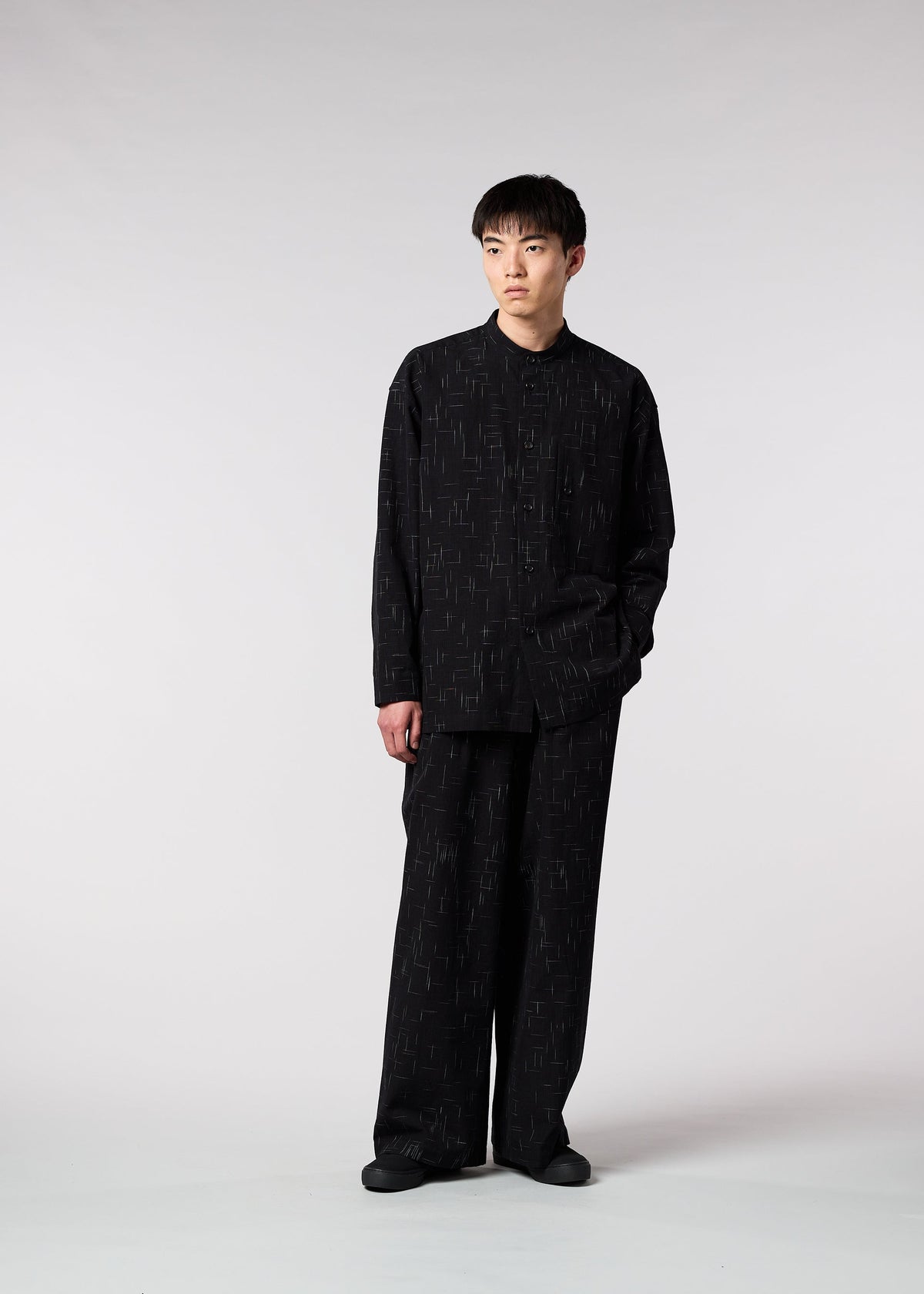 A model wears the IM MEN KASURI trousers.