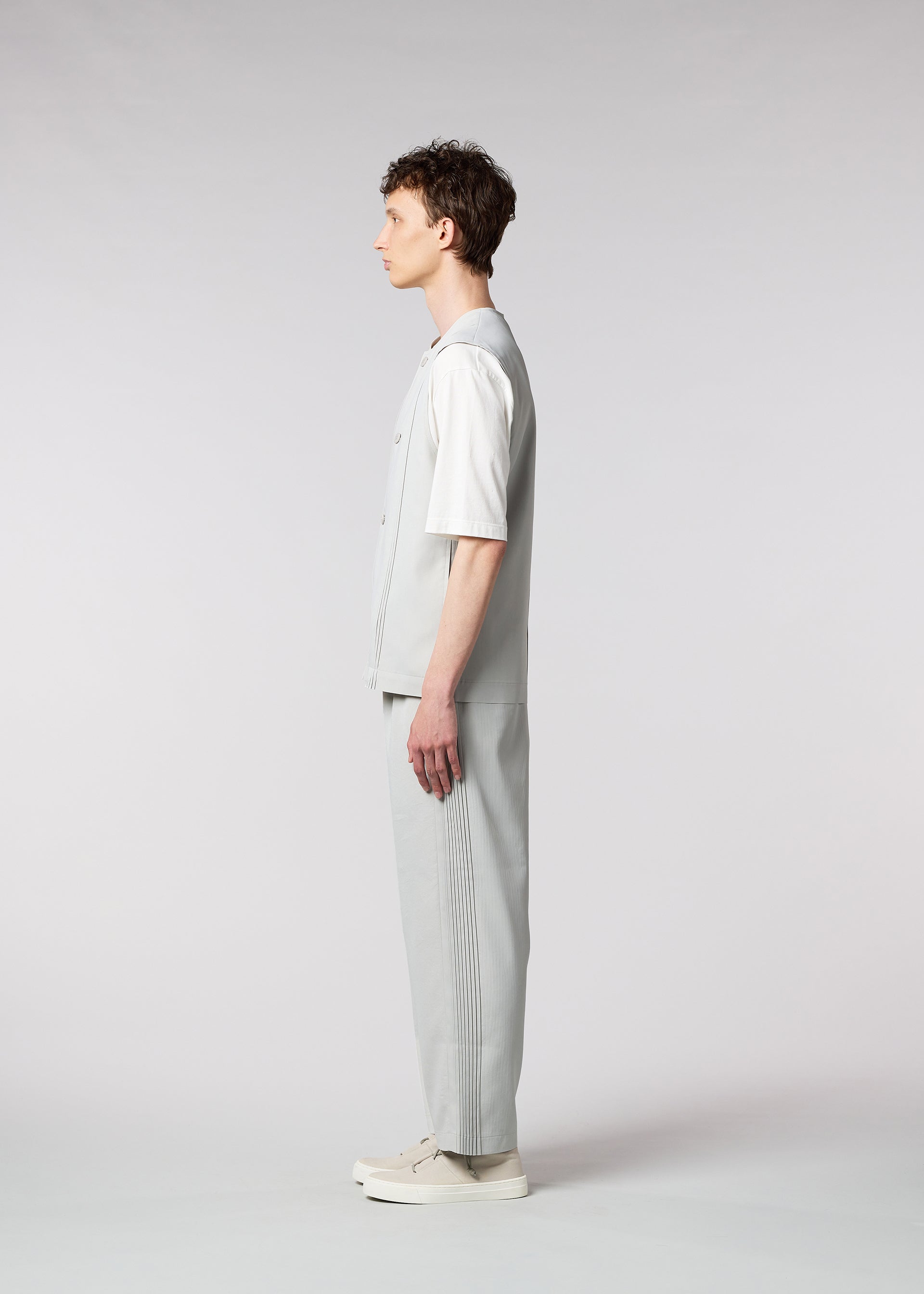 A model wears the IM MEN AIR PLEATS trousers.