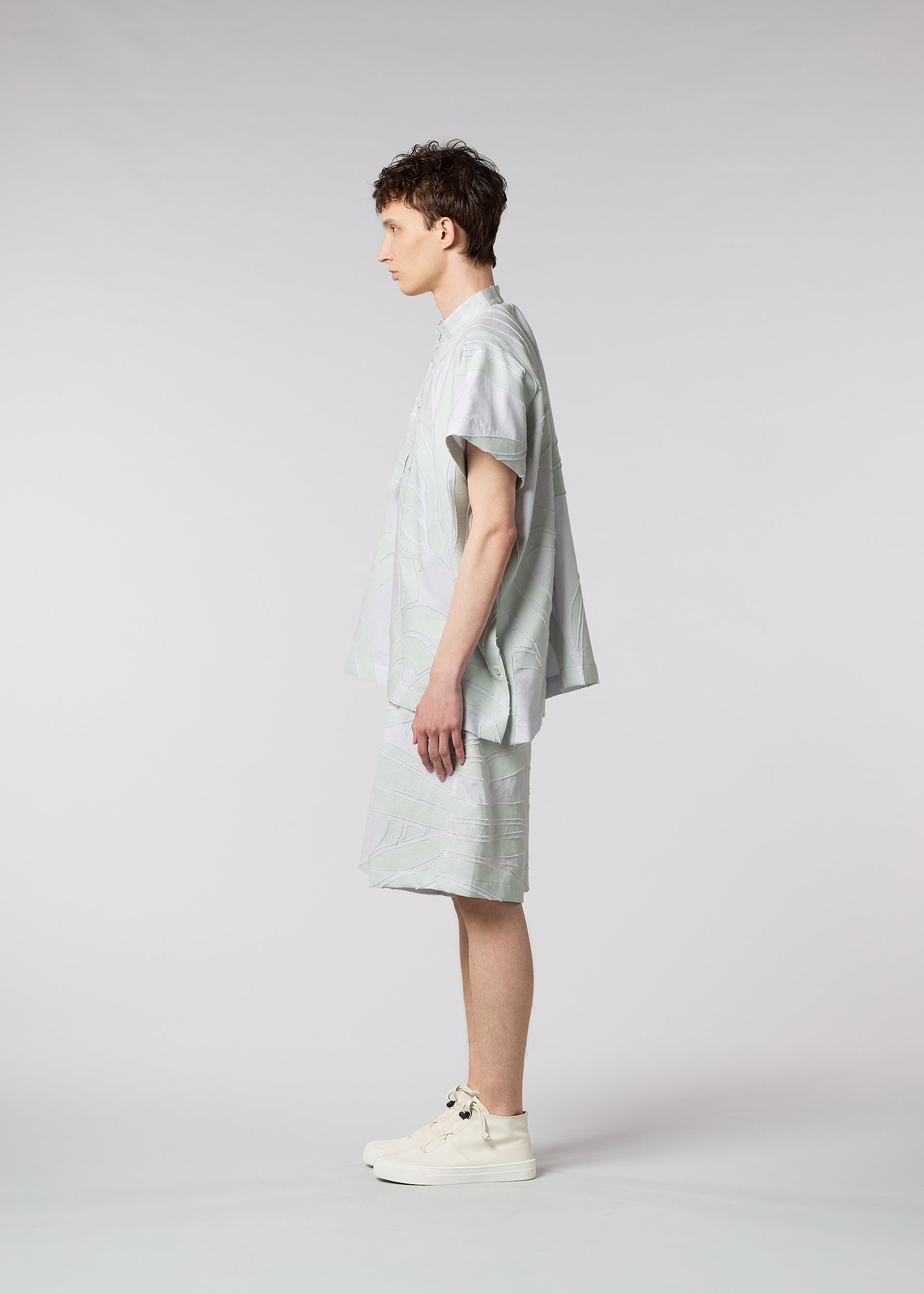 A model wears the ISSEY MIYAKE MEN SCENES trousers.
