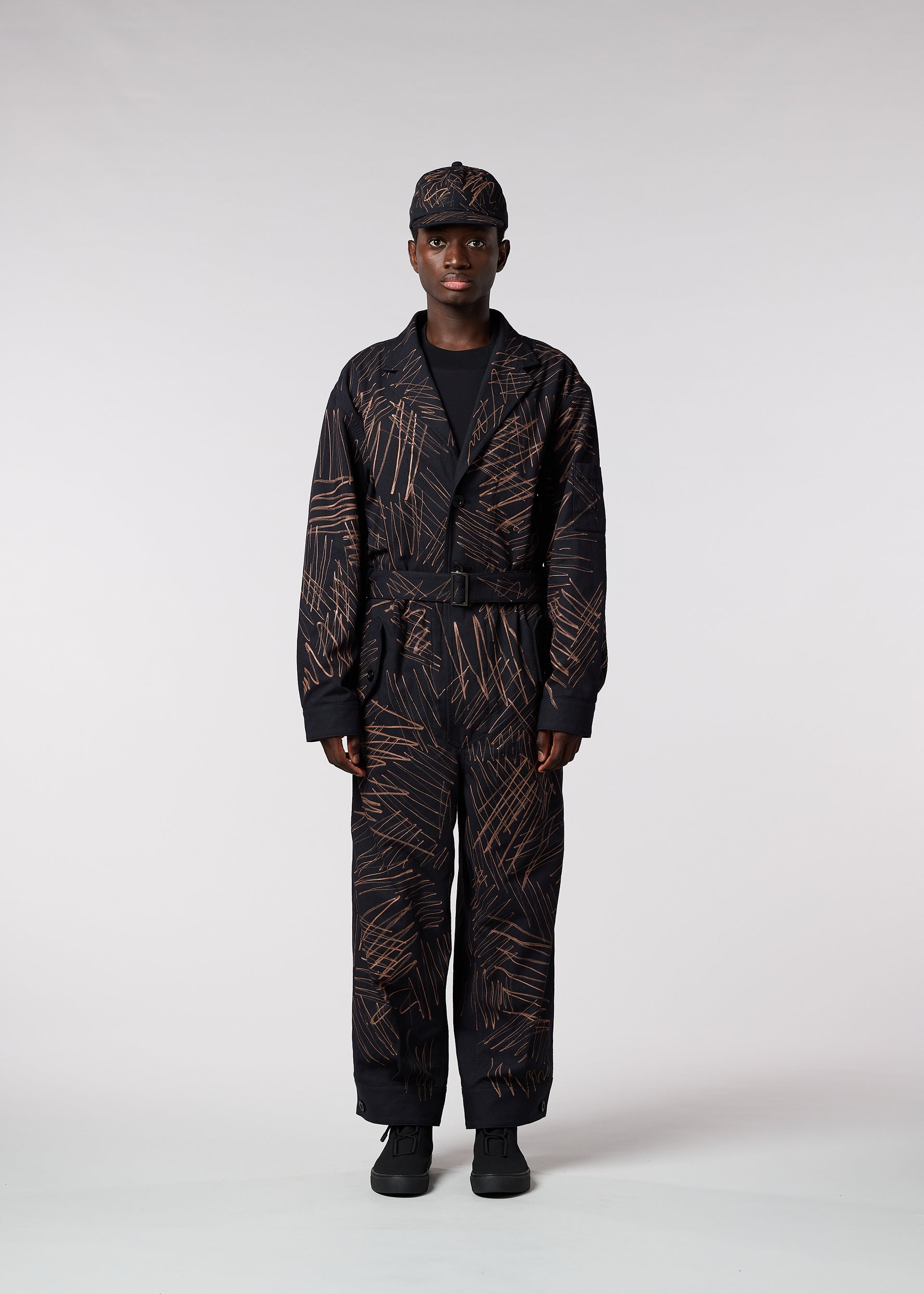 A model wears the IM MEN SKETCH jumpsuit.