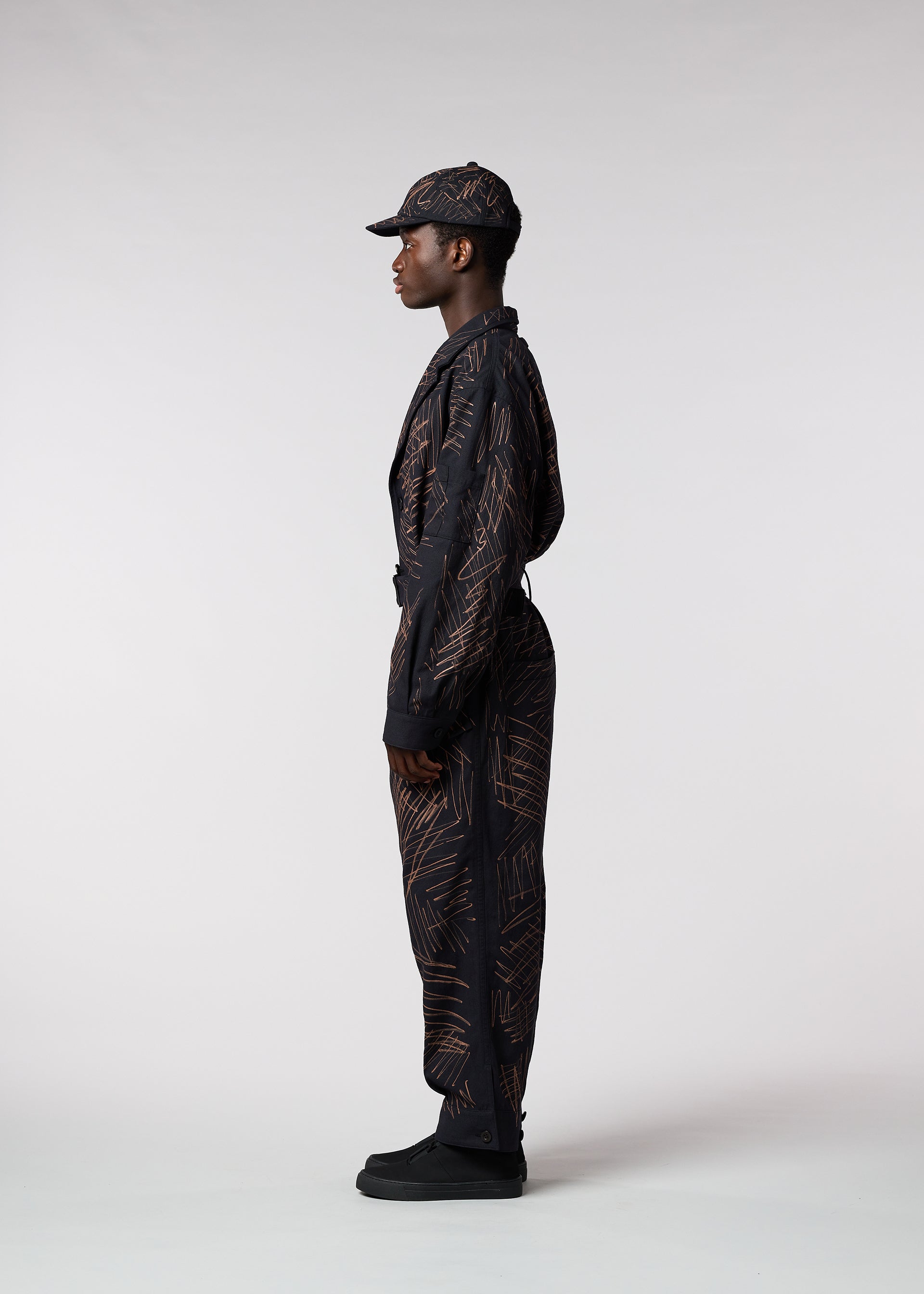 A model wears the IM MEN SKETCH jumpsuit.