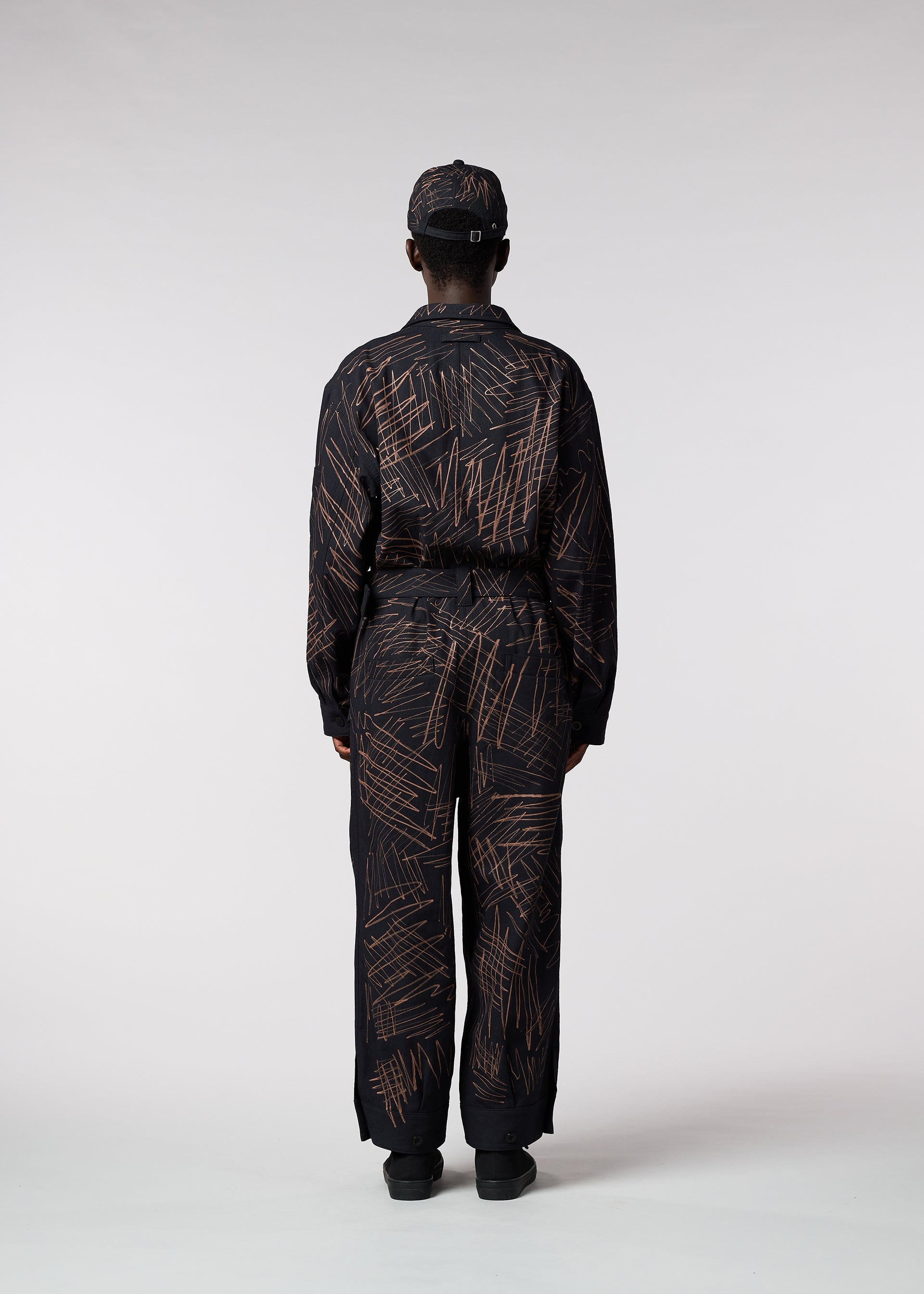 A model wears the IM MEN SKETCH jumpsuit.