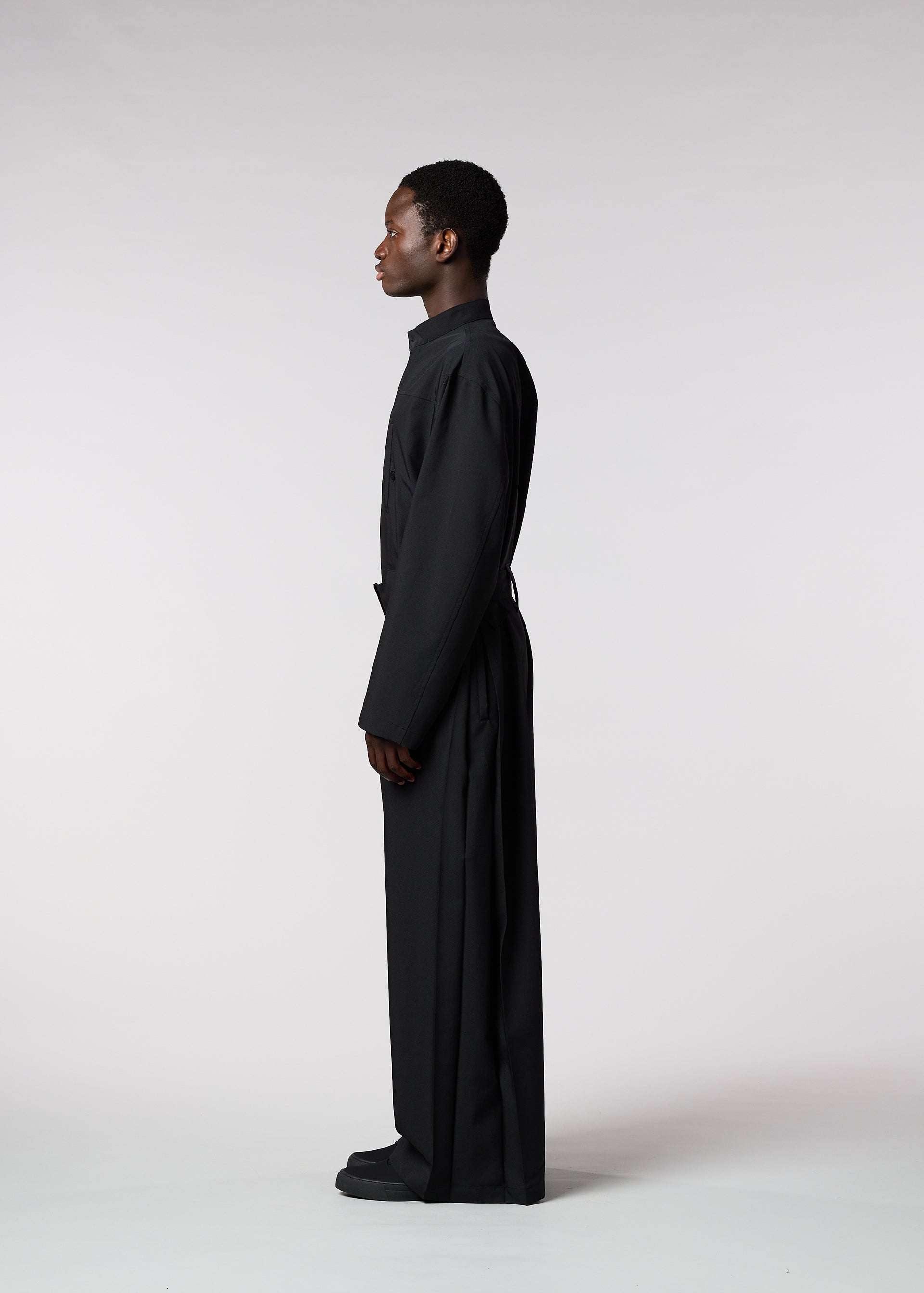 A model wears the ISSEY MIYAKE MEN WINGS jumpsuit.