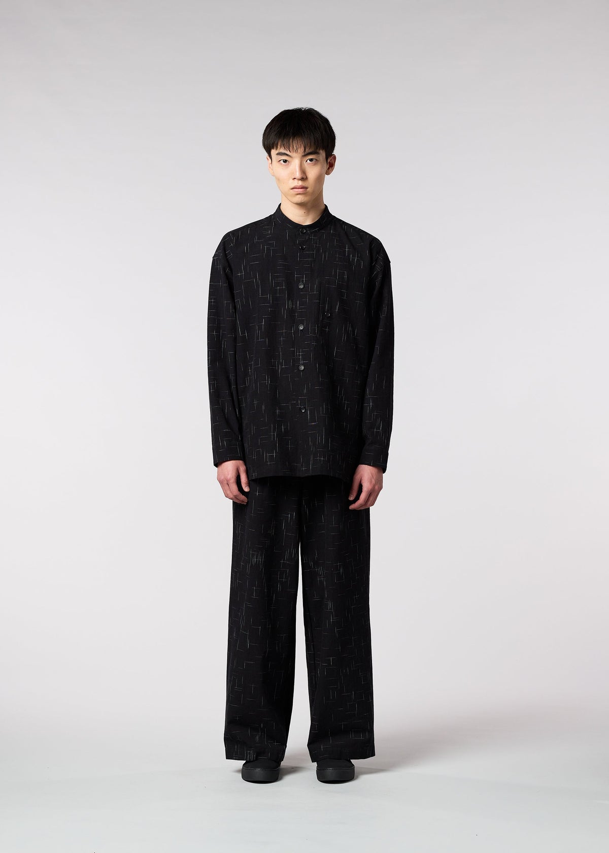 A model wears the IM MEN KASURI shirt.