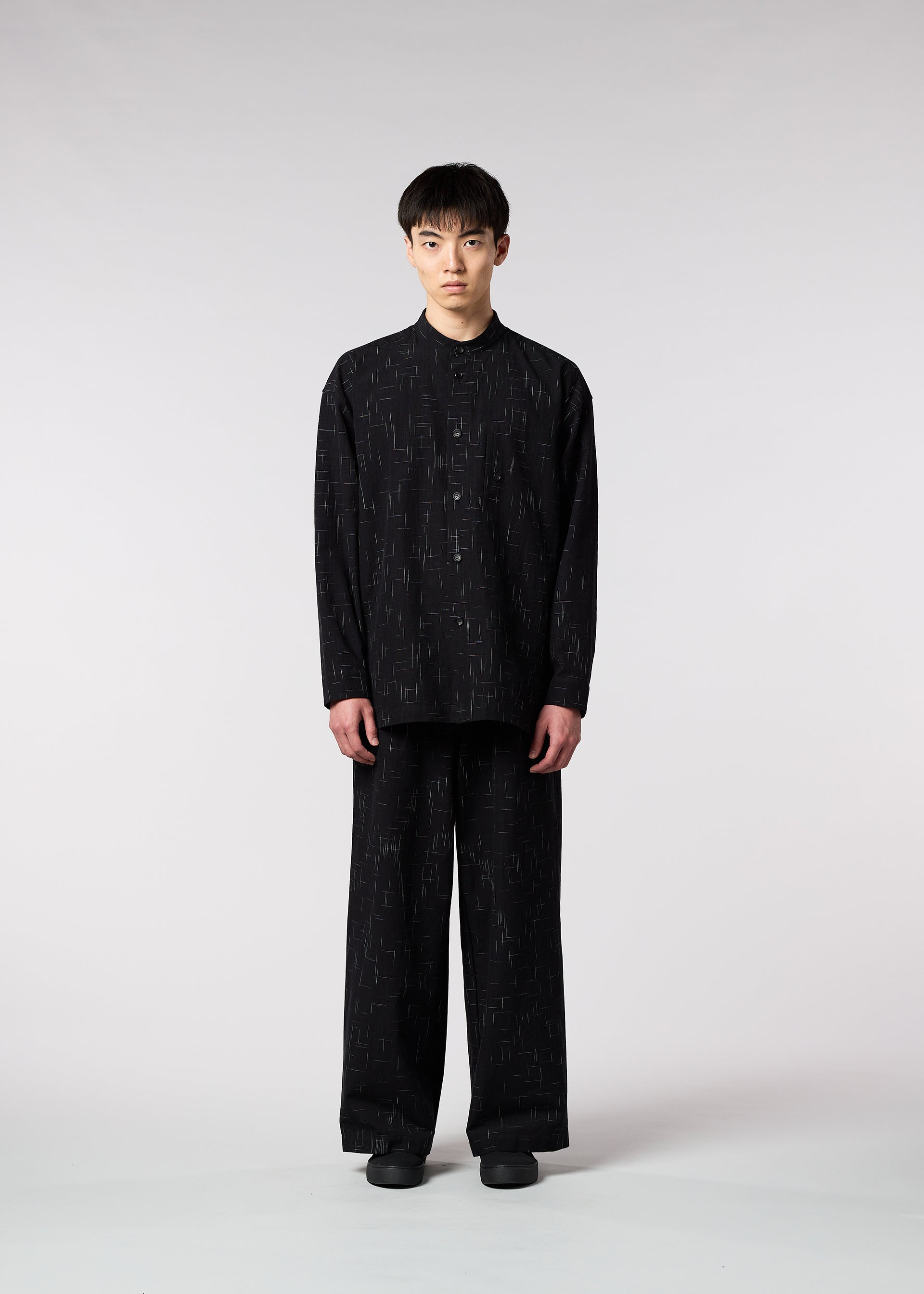 A model wears the IM MEN KASURI shirt.