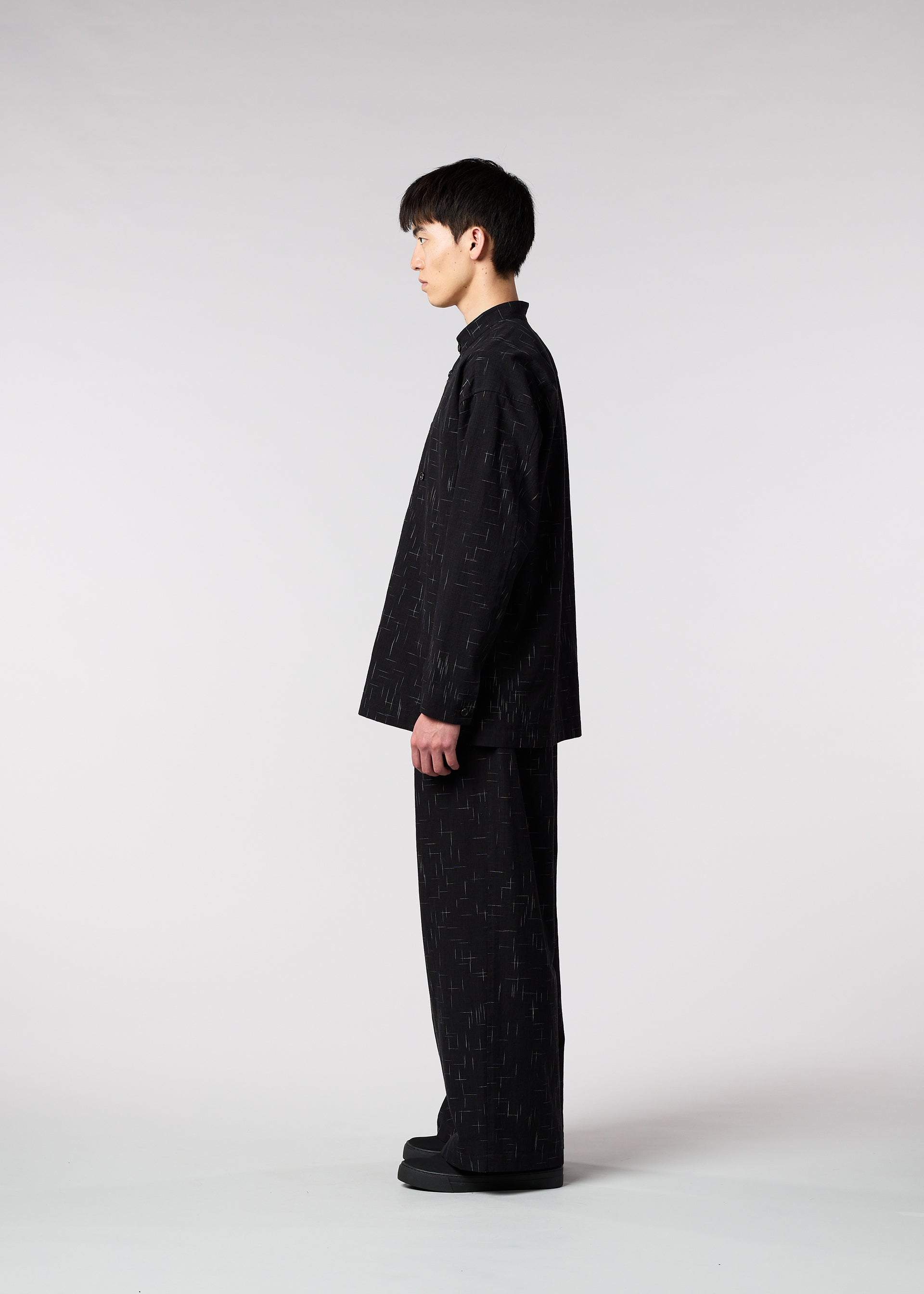 A model wears the IM MEN KASURI shirt.
