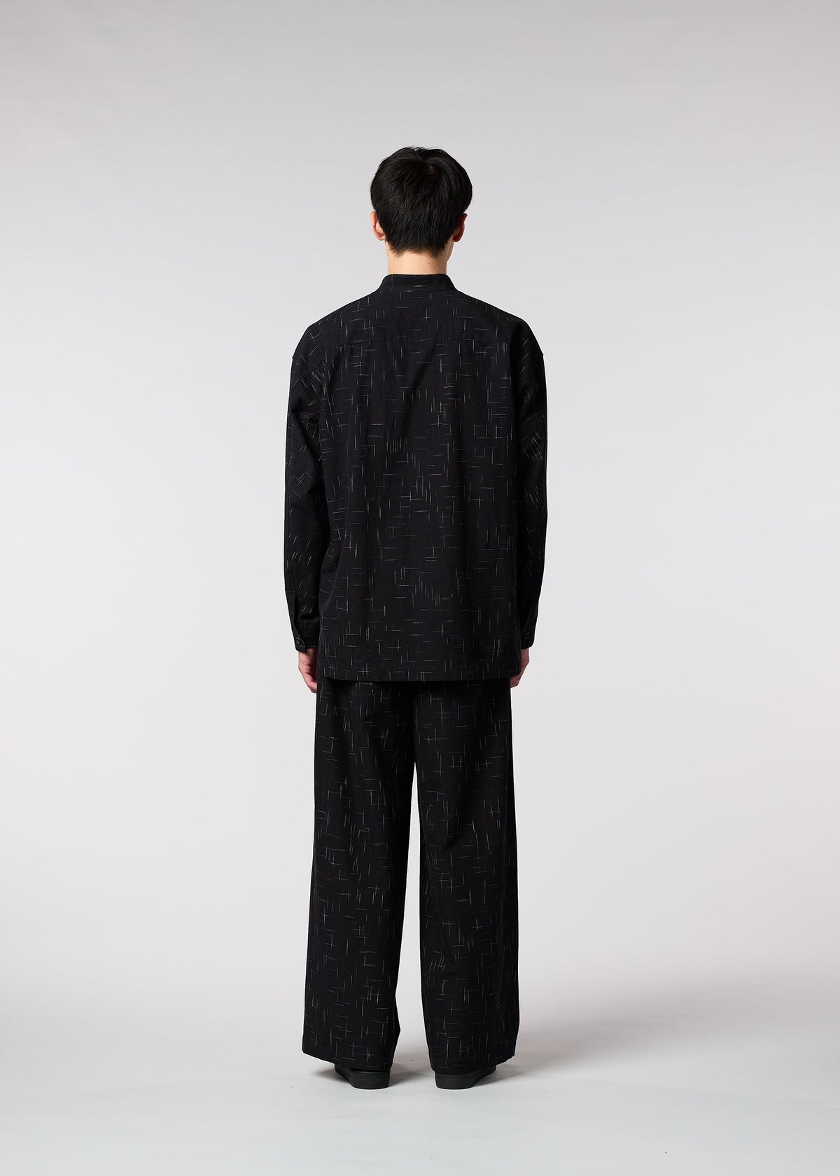 A model wears the IM MEN KASURI shirt.