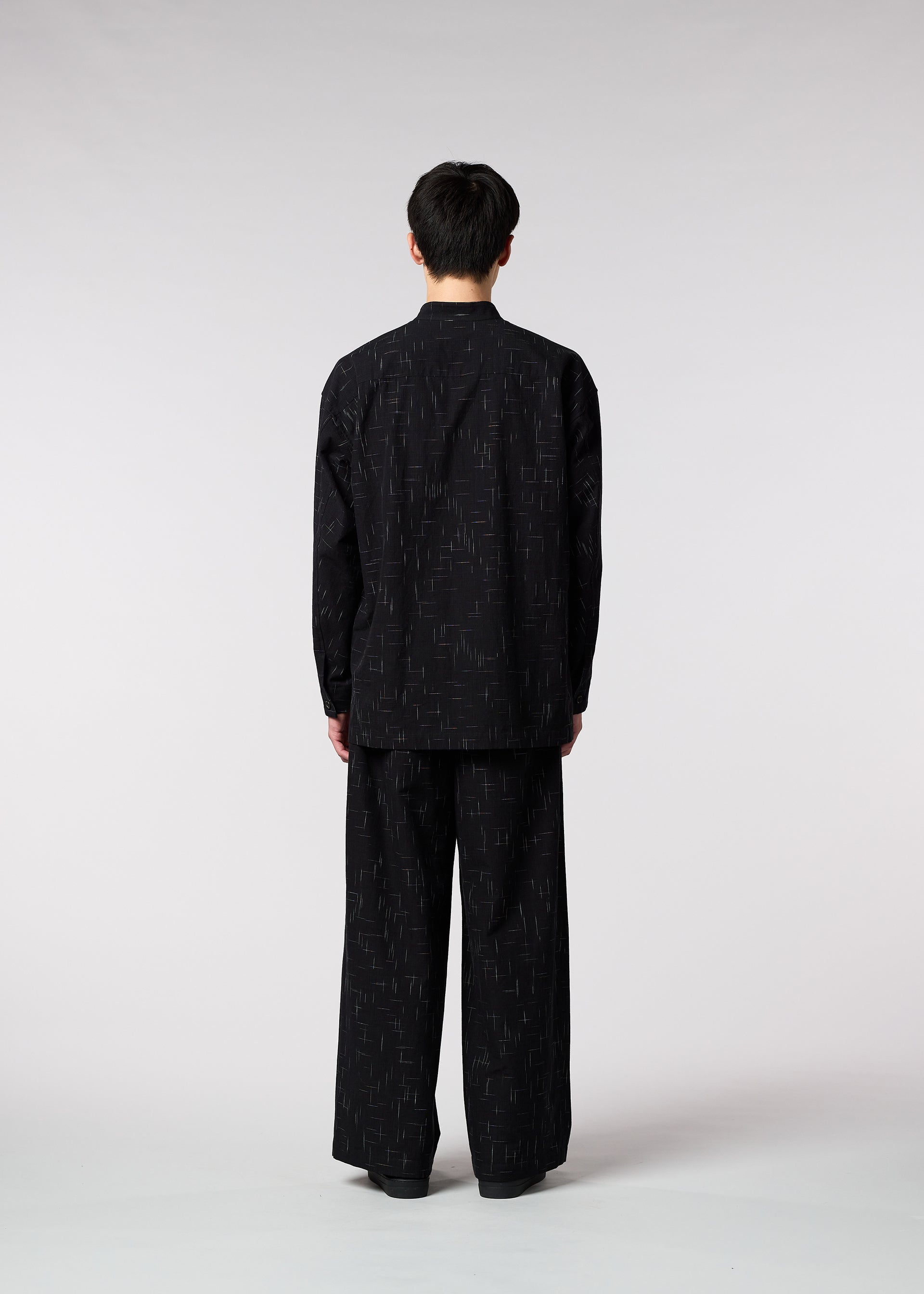 A model wears the IM MEN KASURI shirt.