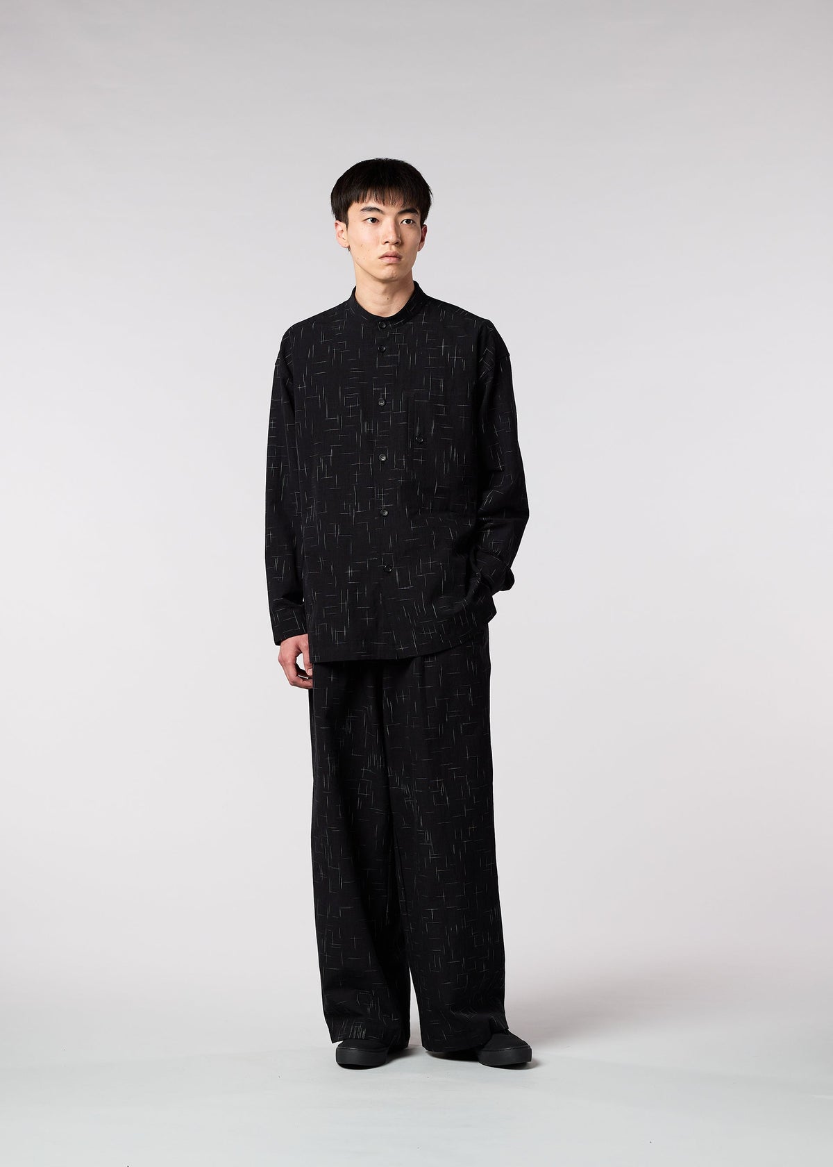 A model wears the IM MEN KASURI shirt.