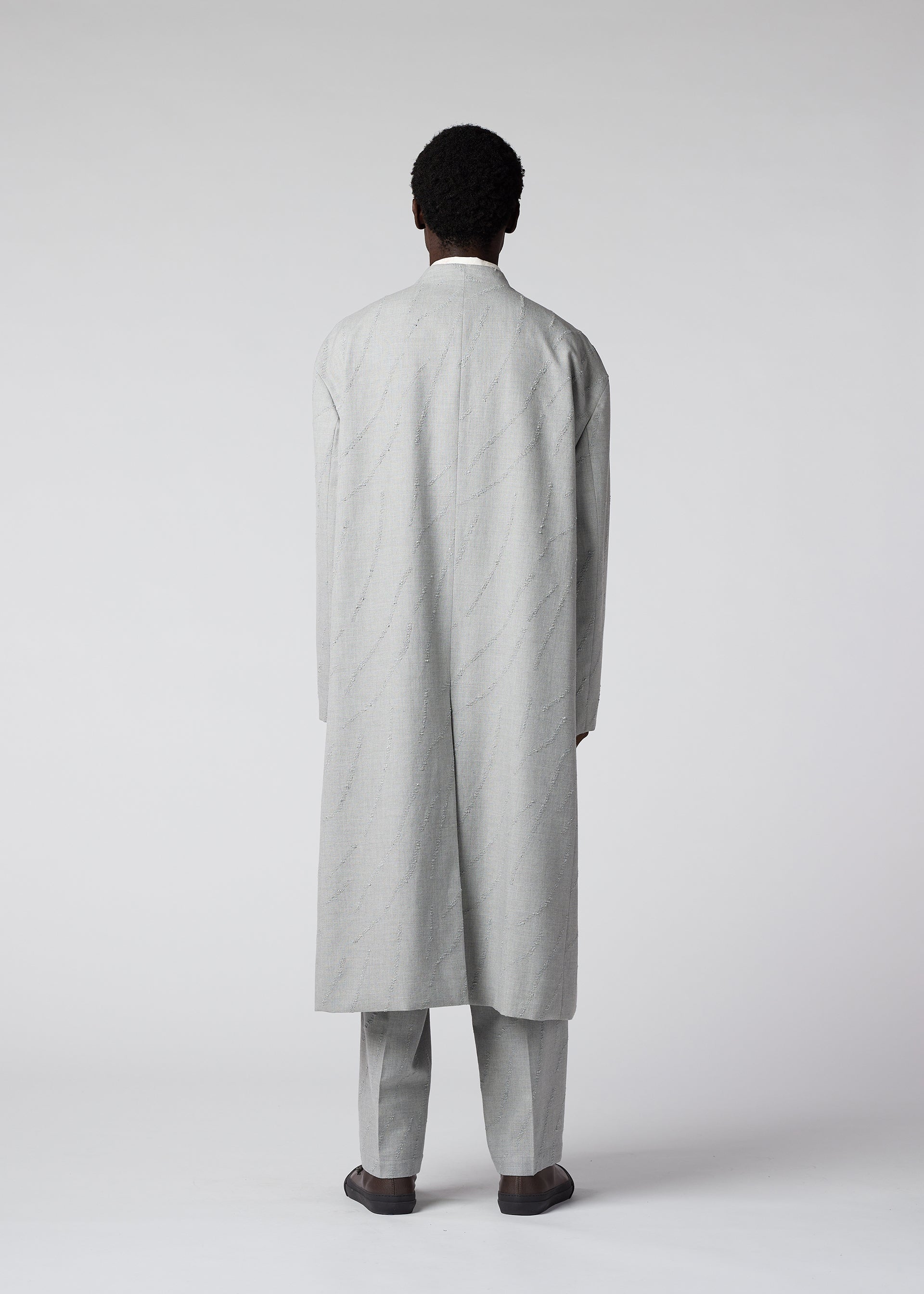 A model wears the IM MEN FLY WOOL coat.