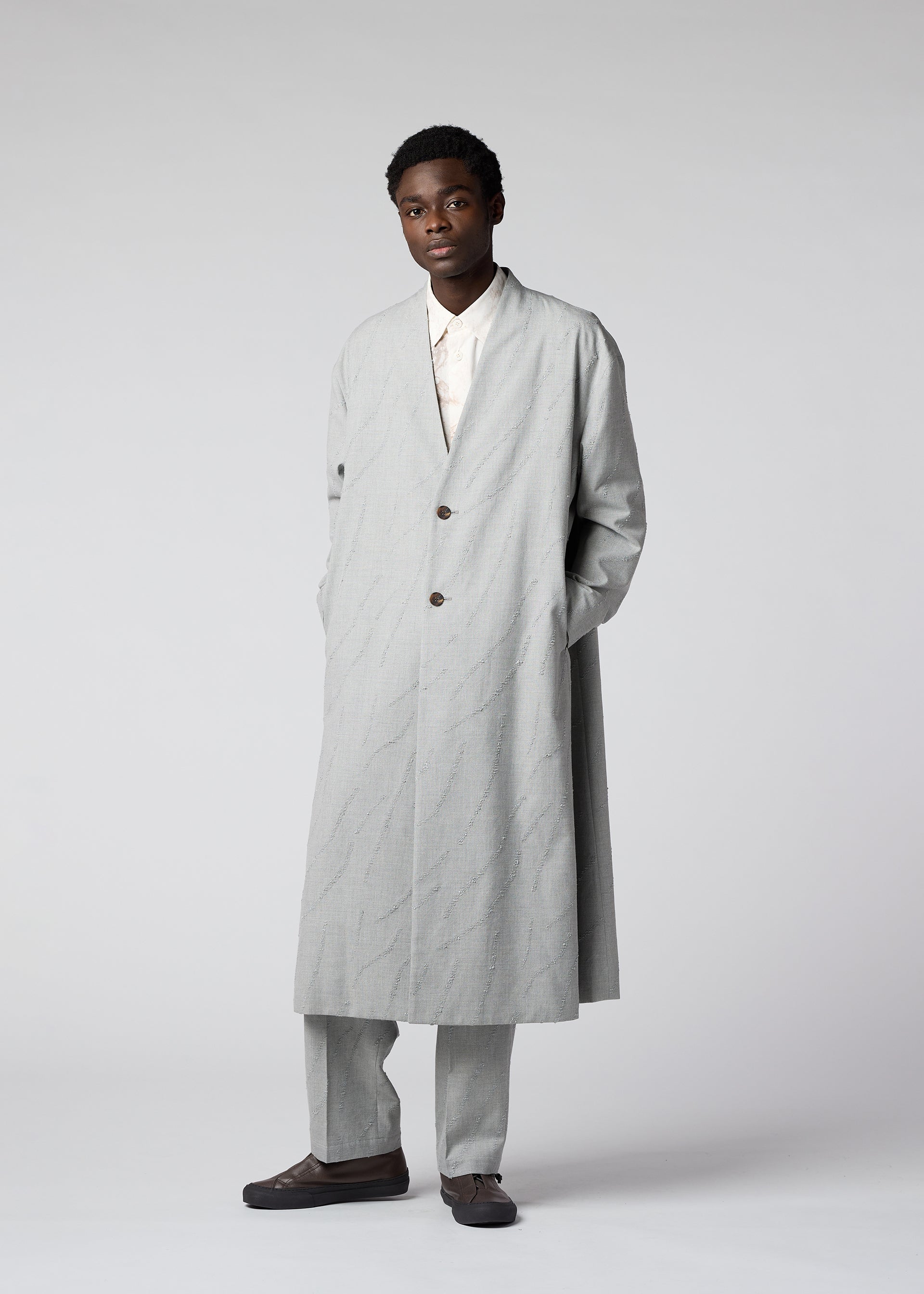 A model wears the IM MEN FLY WOOL coat.