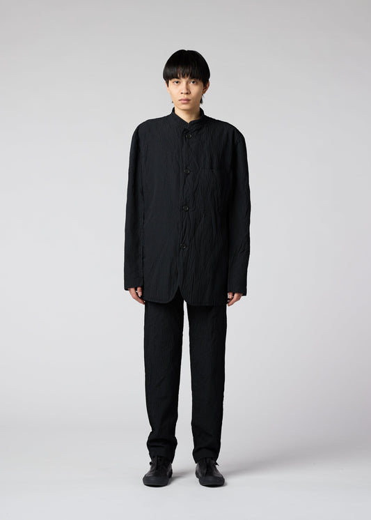 A model wears the IM MEN SHRINK DYE trousers.