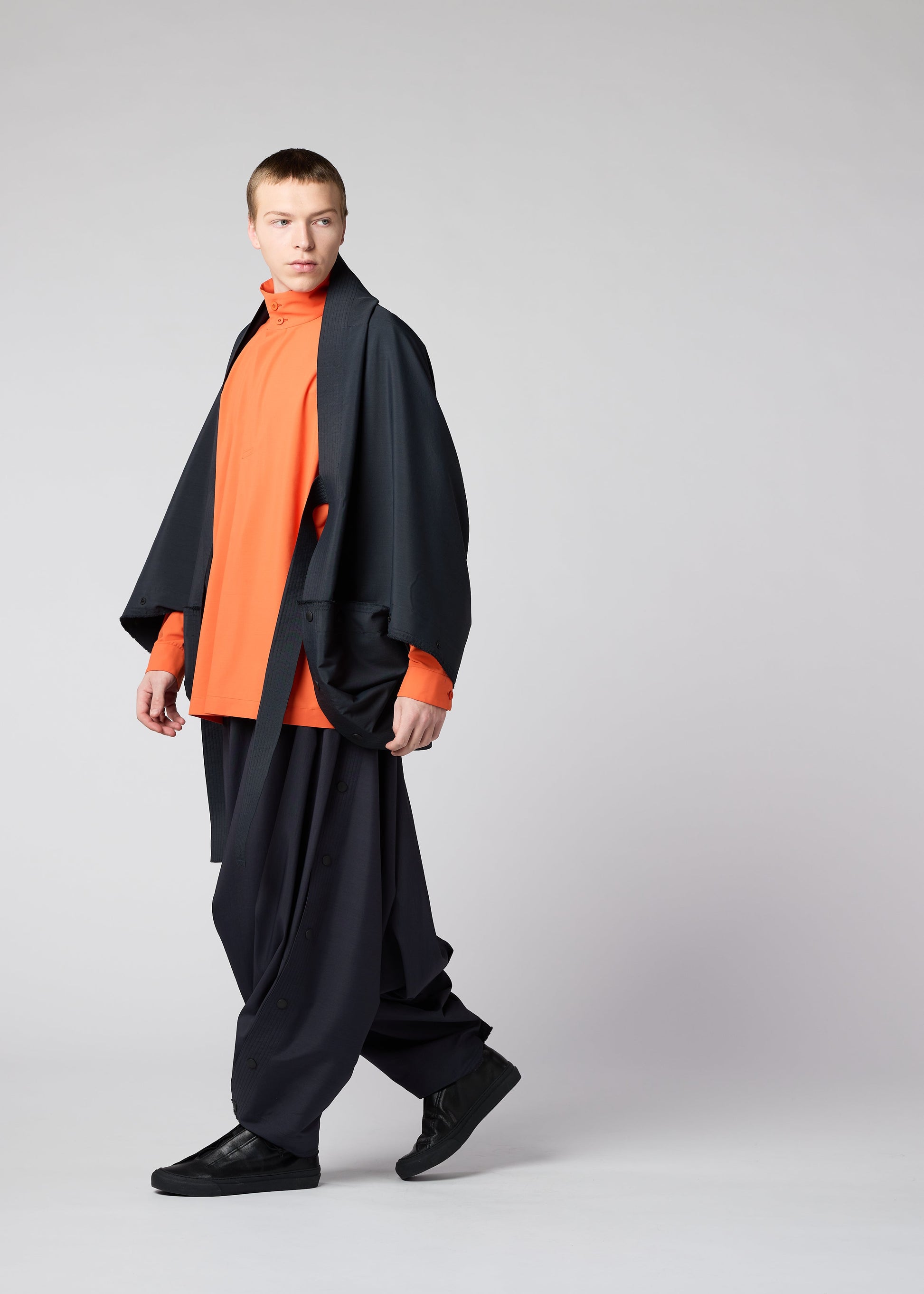 A model wears the IM MEN FLY trousers.