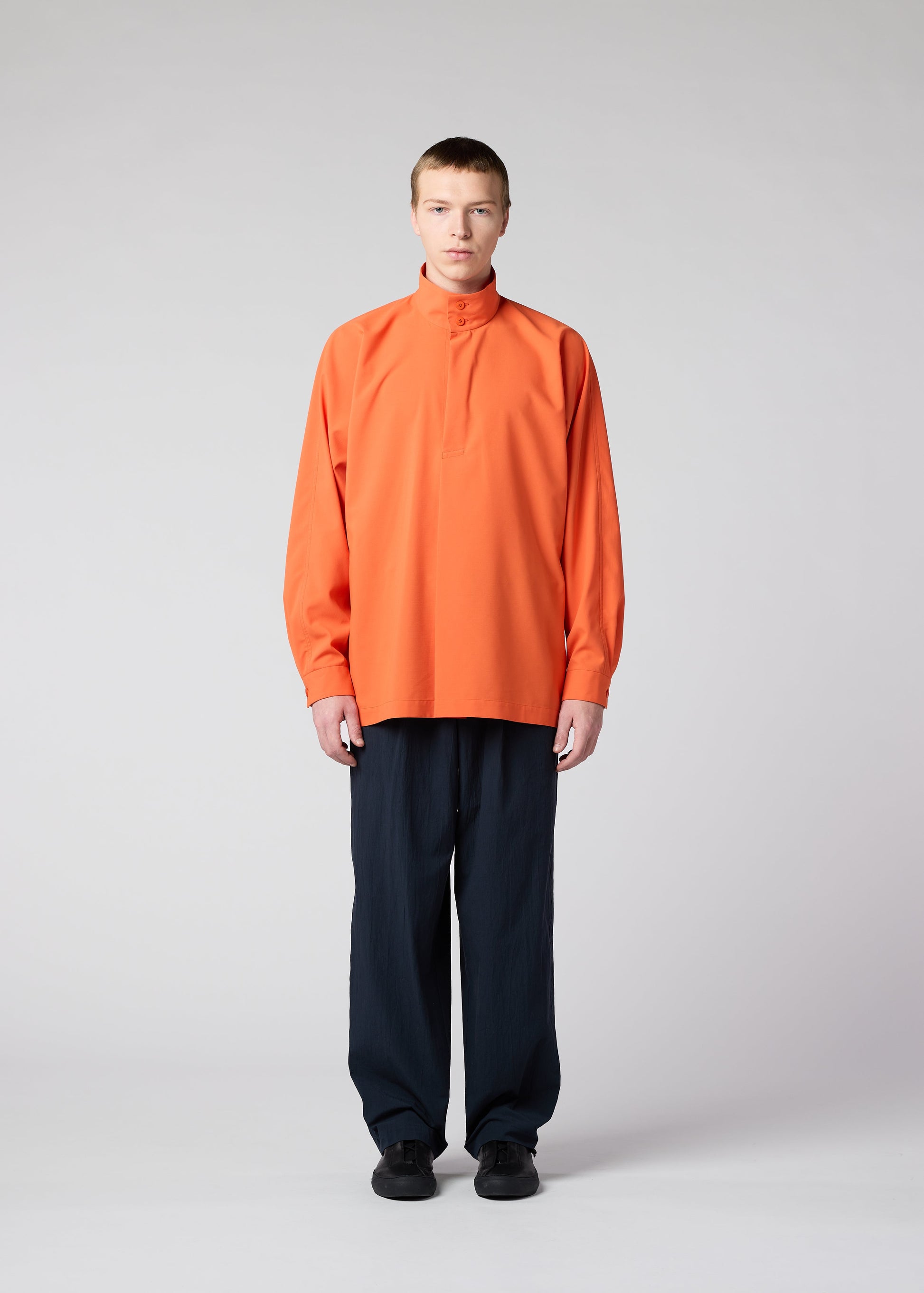 A model wears the IM MEN NAVY BOTTOMS trousers.
