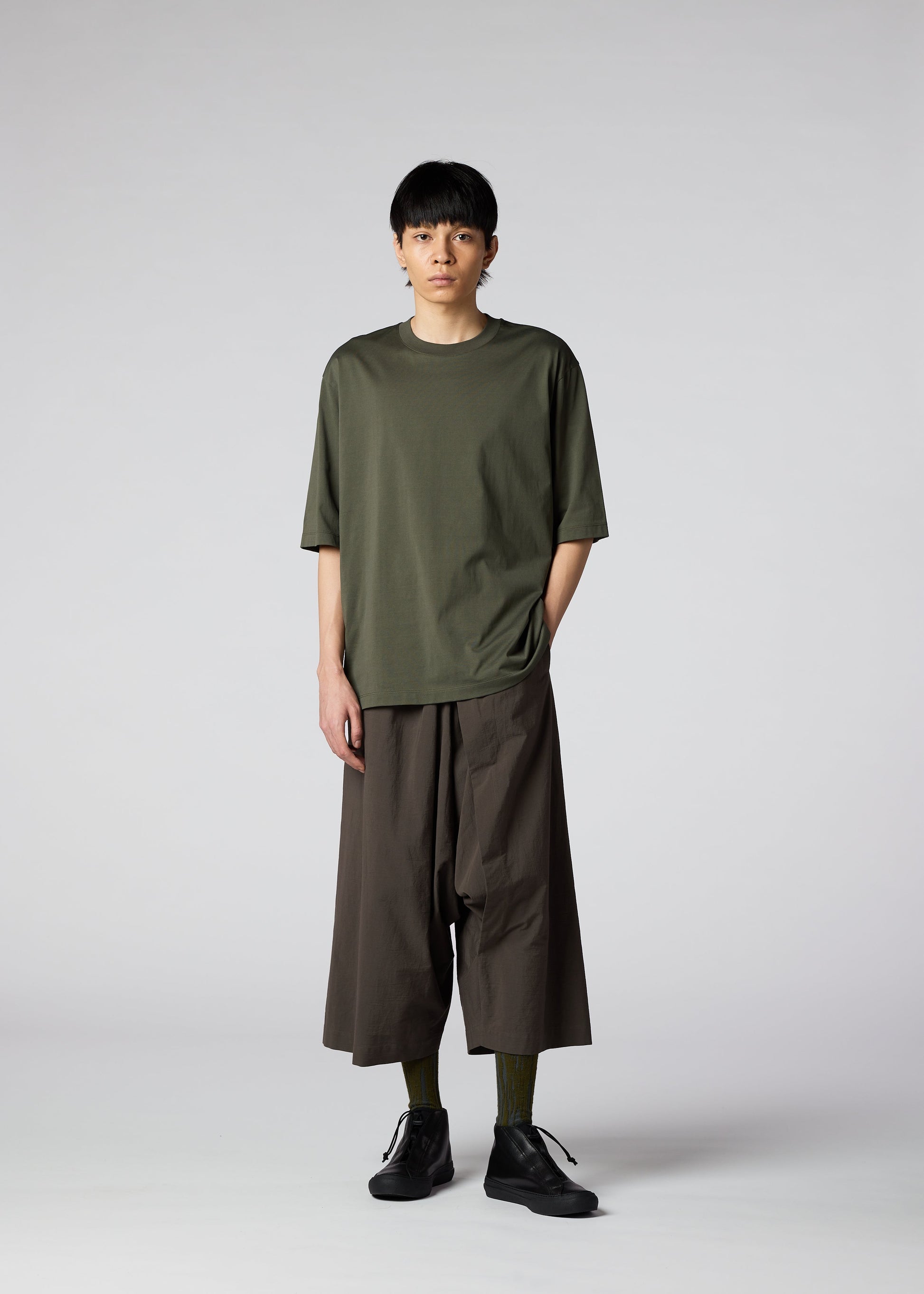 A model wears the IM MEN NAVY BOTTOMS trousers.