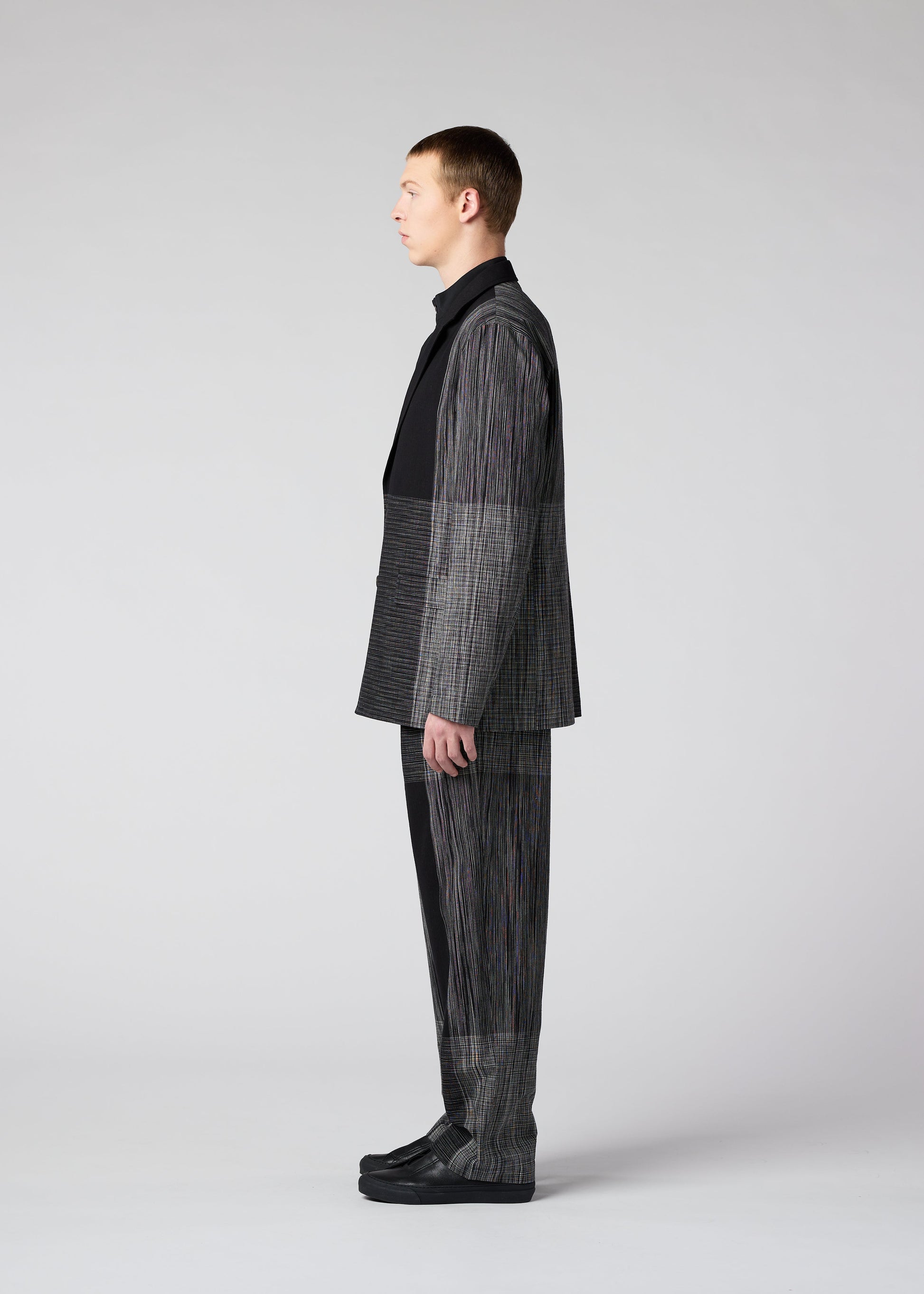 A model wears the IM MEN KASURI trousers.