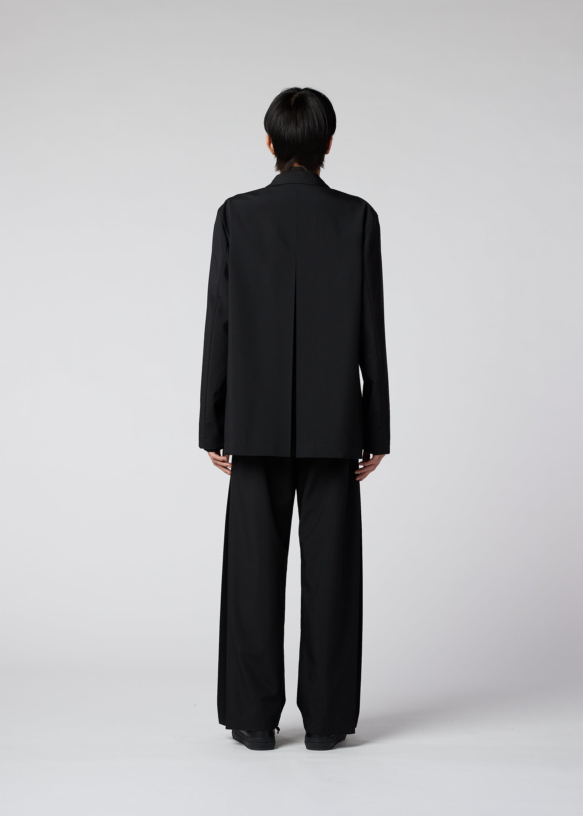 A model wears the IM MEN WINGS trousers.